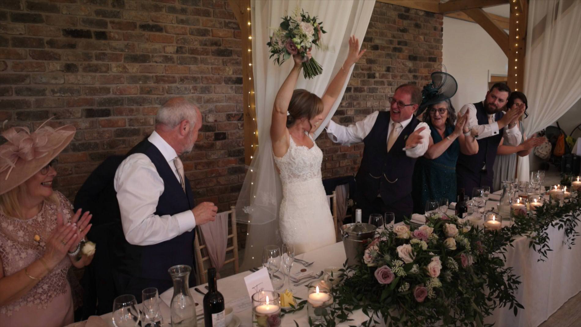 the bride cheers as she takes her seat