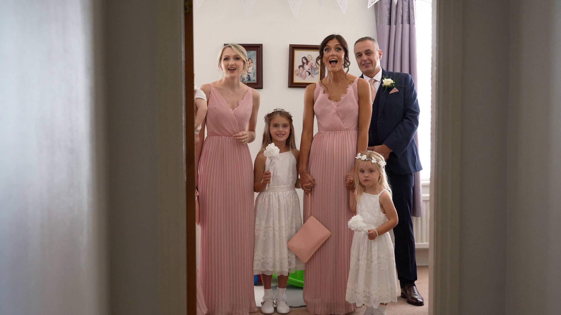 the bridesmaids react to the first look of the bride