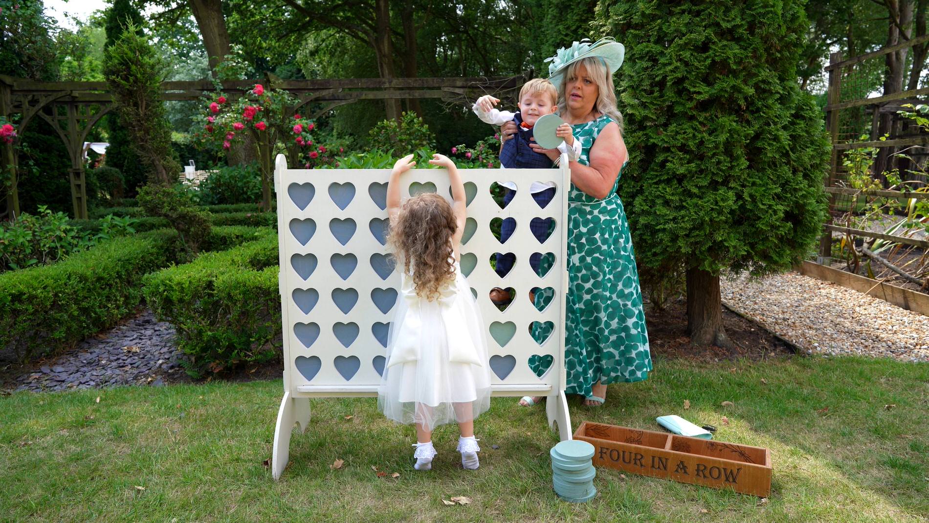 wedding guests enjoy the Shindigs of Sherwood connect 4 game at Nunsmere hall
