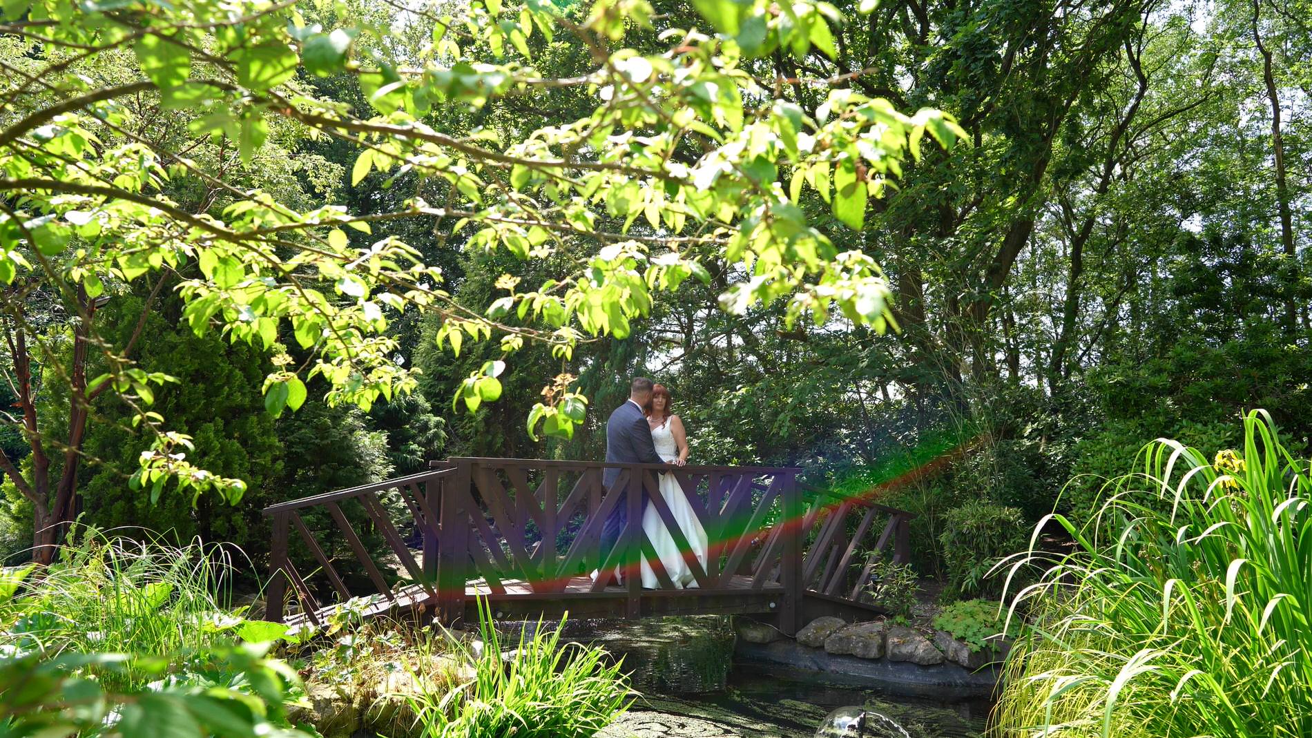 a video still of the couple by the lake at Nunsmere hall