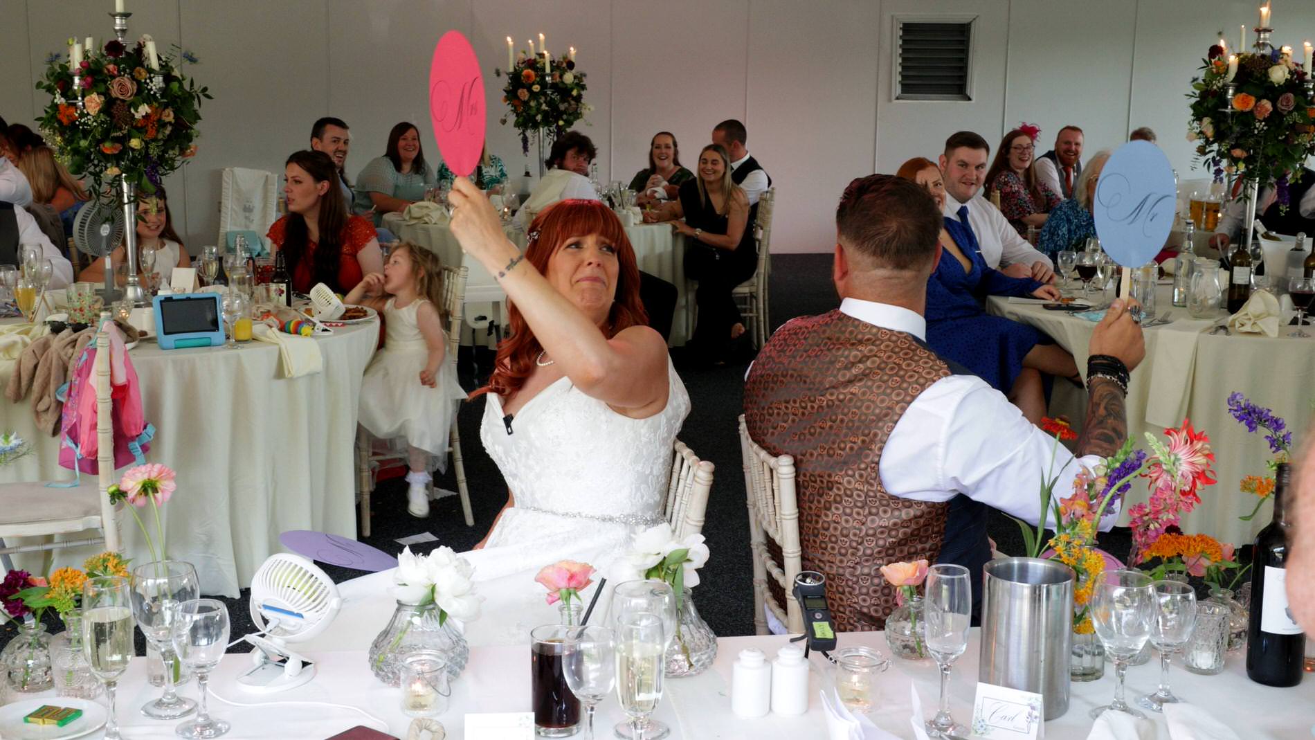 a couple play mr and mrs in the marquee at Nunsmere hall