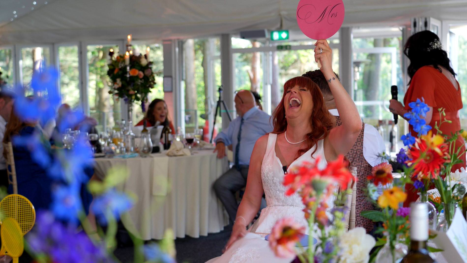 a video still of a couple laughing during a mr and mrs game at Nunsmere hall