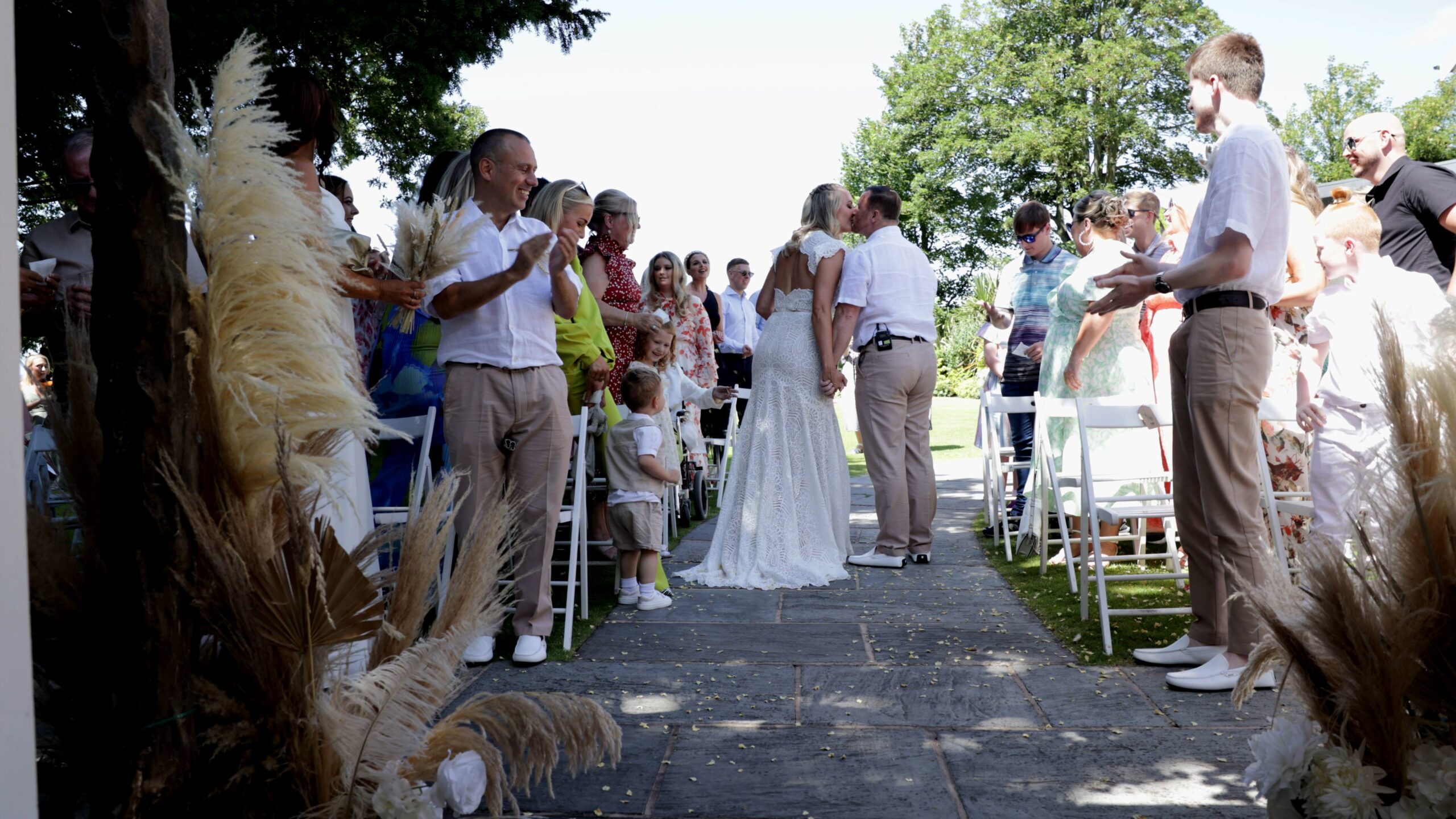 a couple kiss after their outdoor vow renewal