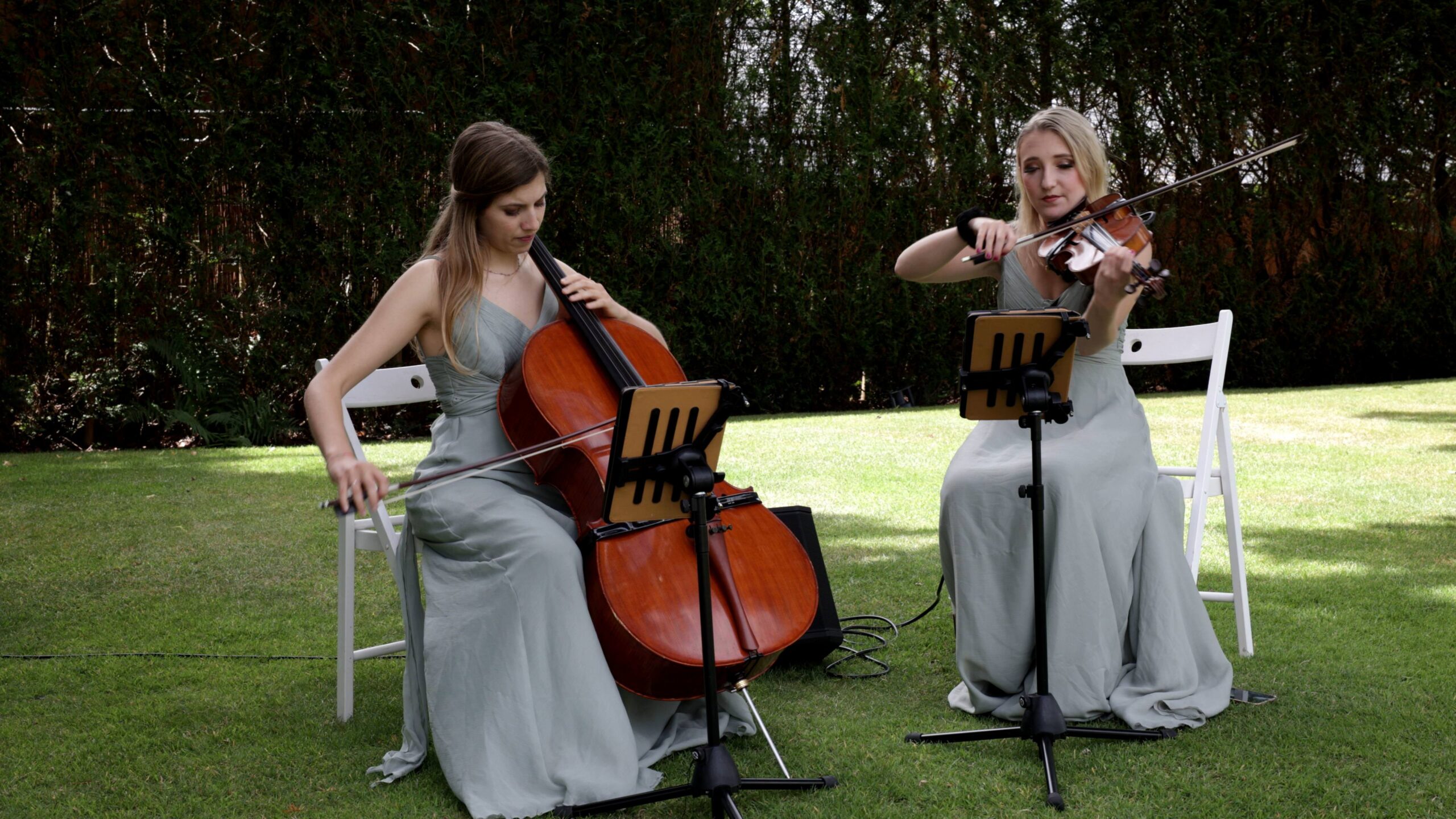 a string duo play ready for the wedding ceremony