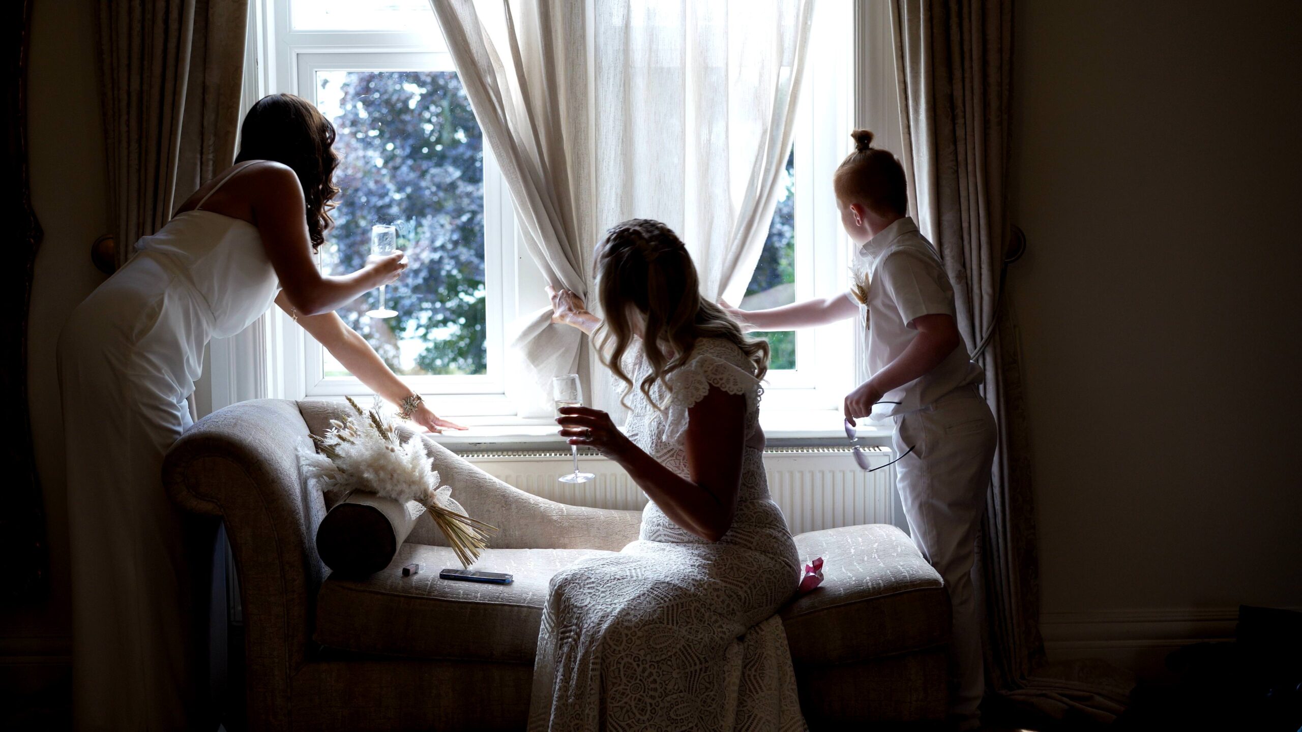 the bridal party try to sneak a look outside at the wedding