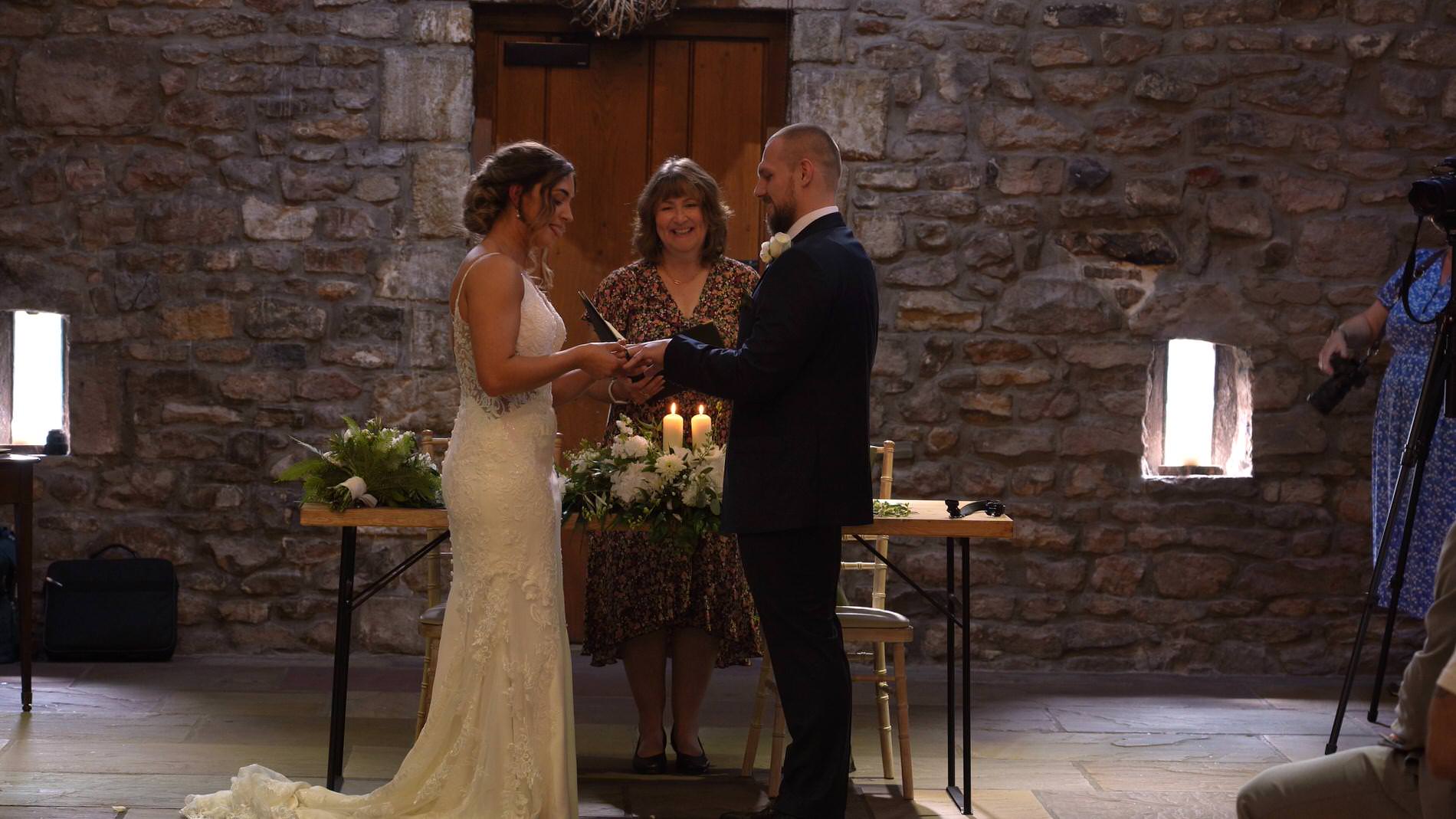 a couple exchange rings during their Browsholme Hall ceremony