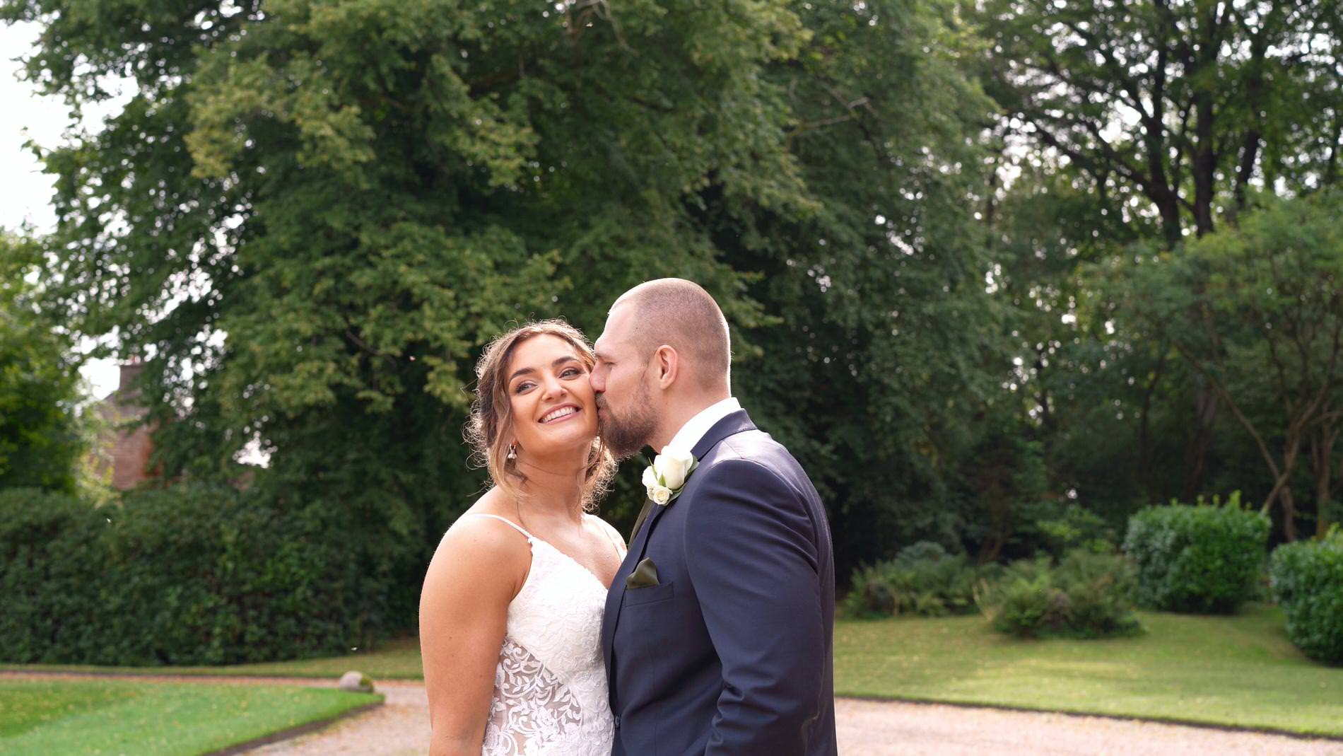 a couple smile as they're filmed for their natural wedding moments at Browsholme Hall