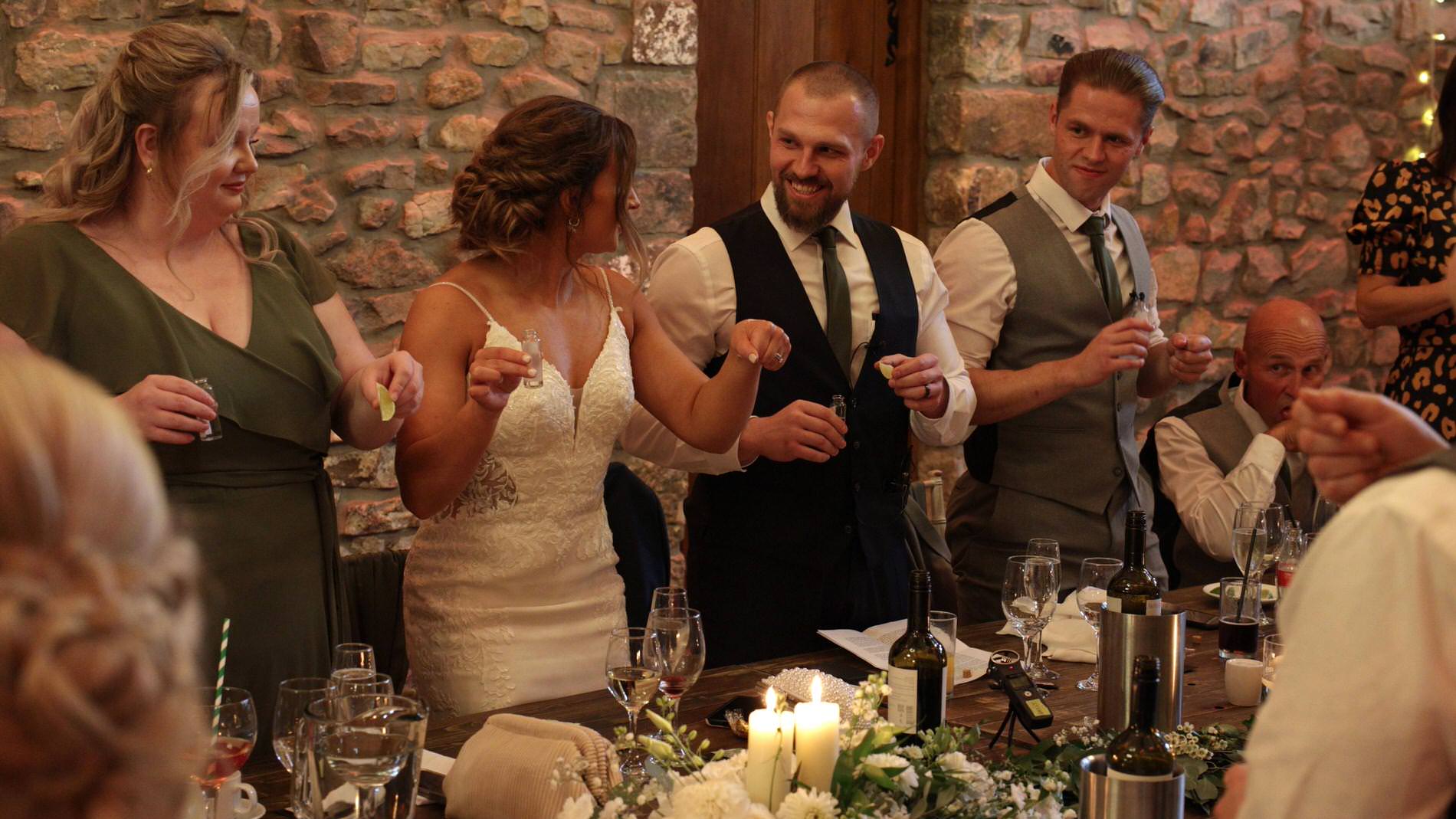 the couple and their guests are filmed getting shots ready