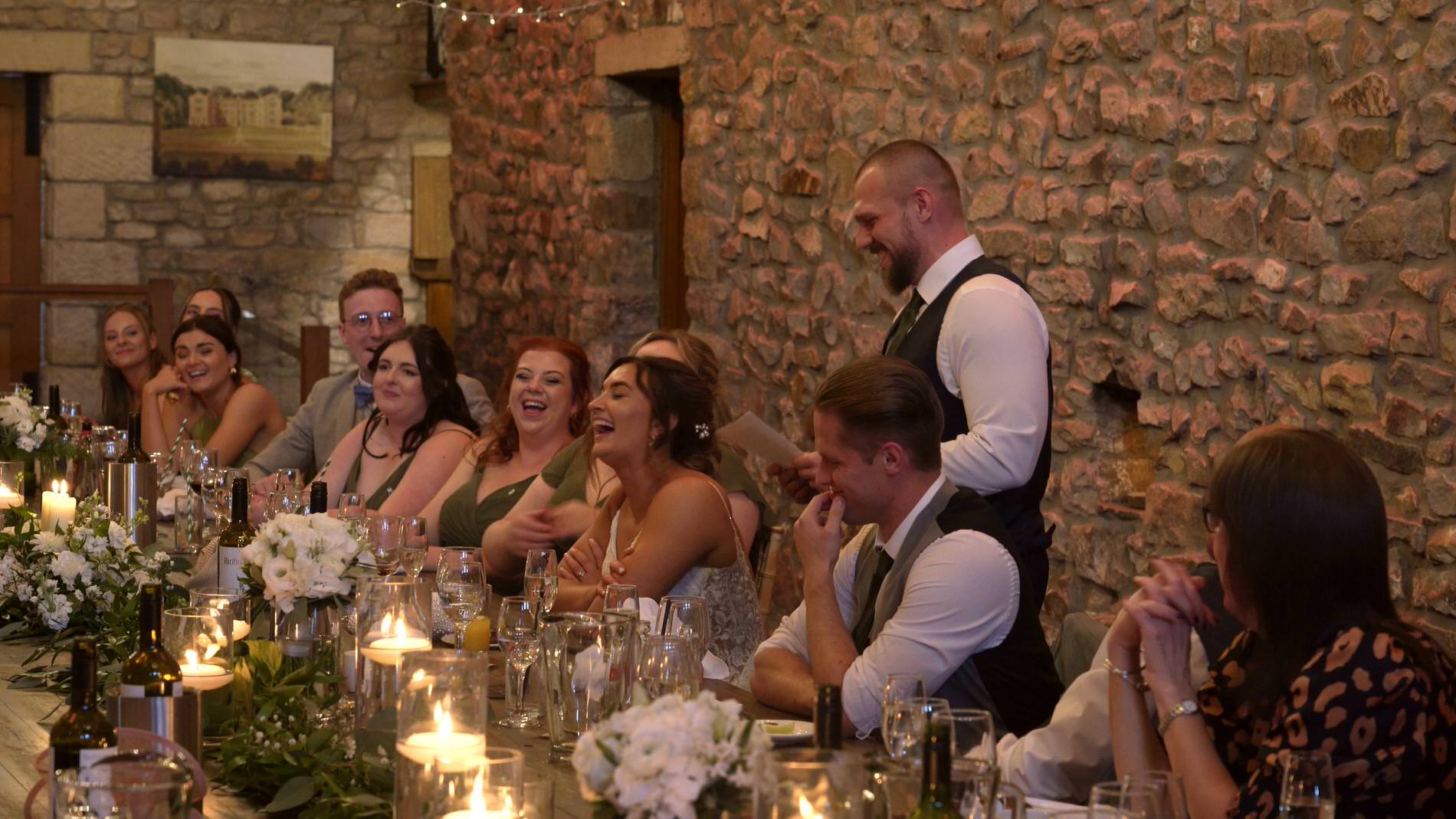 the groom stands to speak during a intimate wedding reception at Browsholme Hall
