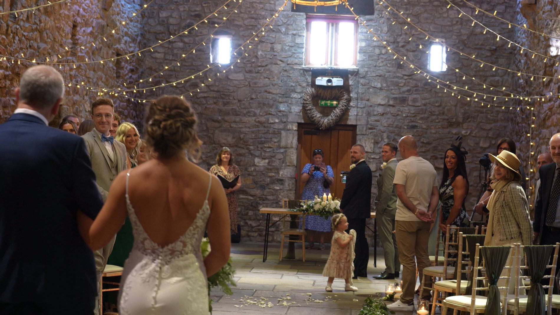 a bride walks towards a groom about to cry before their Browsholme Hall wedding ceremony