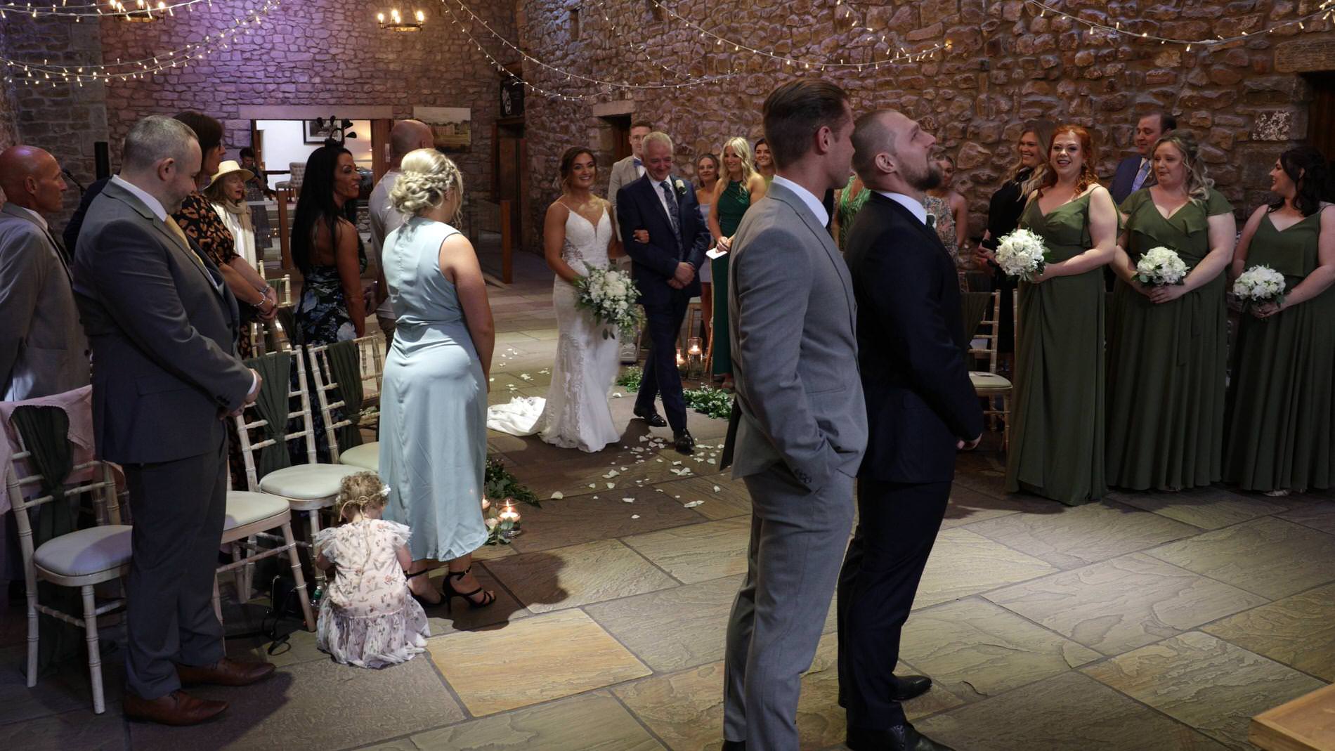the groom looks up to stop tears forming after seeing his bride for the first time