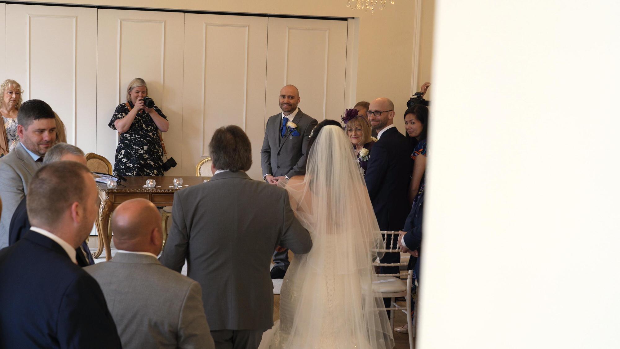a bride walks down the aisle indoors at West Tower ormskirk