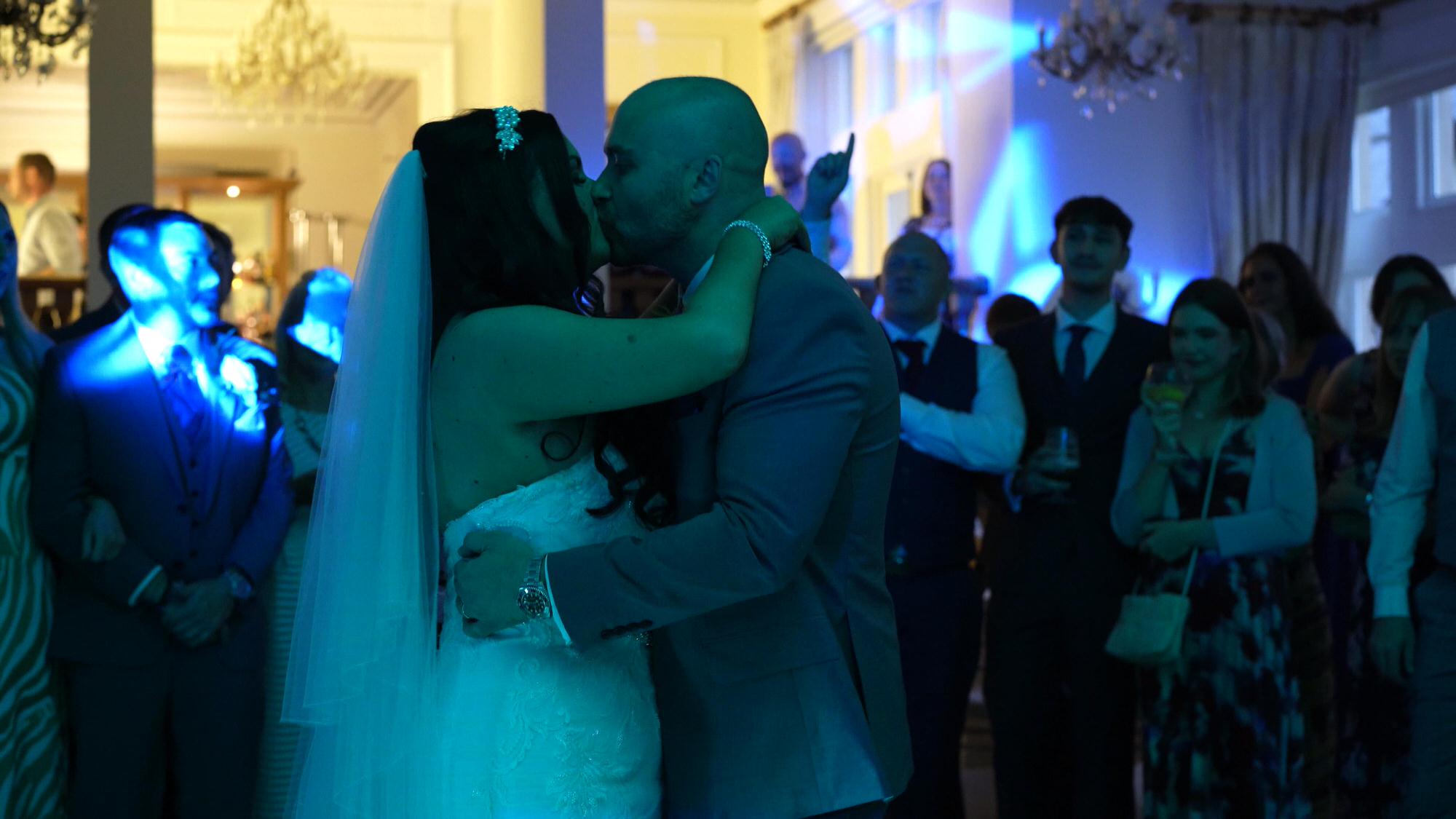 the couple kiss during first dance at West Tower