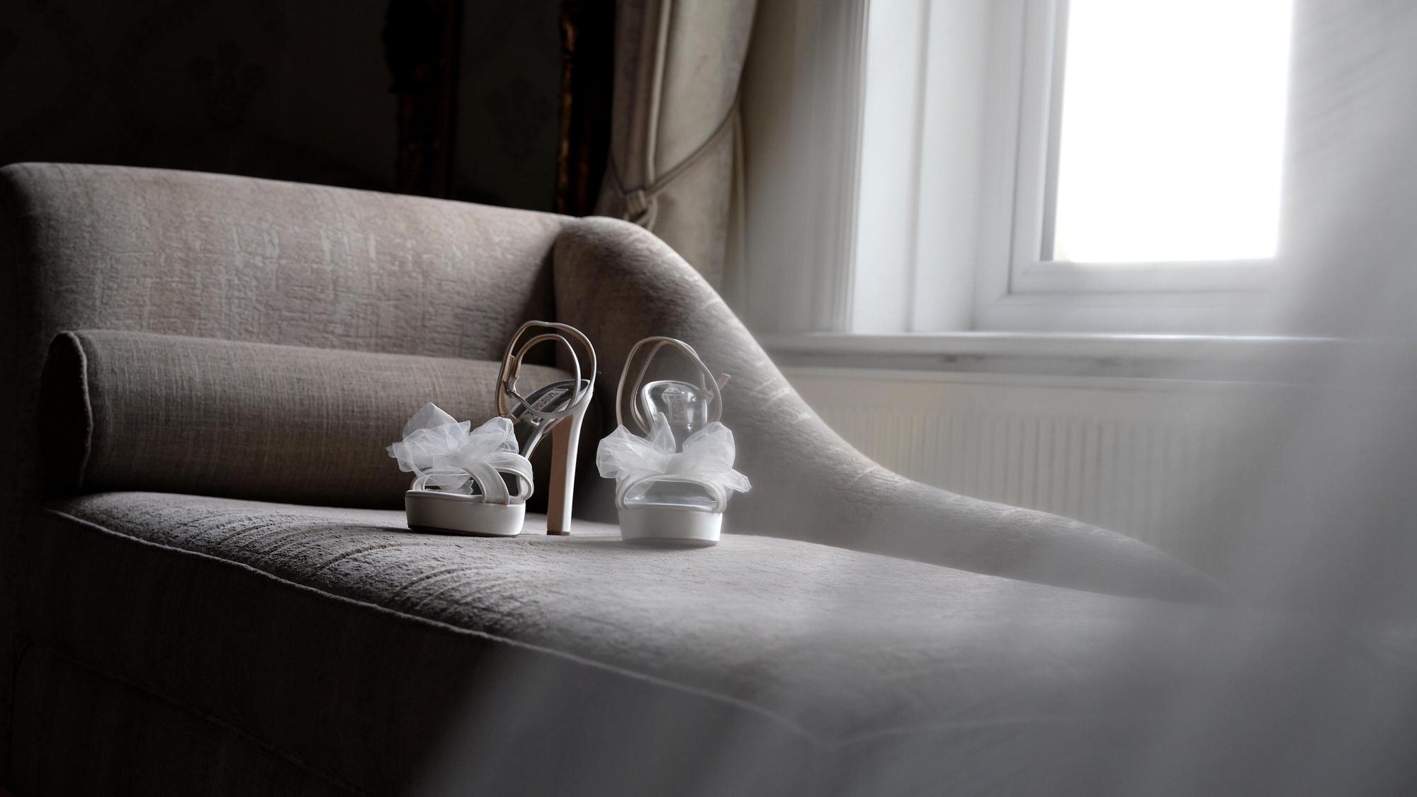 pretty bridal shoes sit on the chaise at West Tower