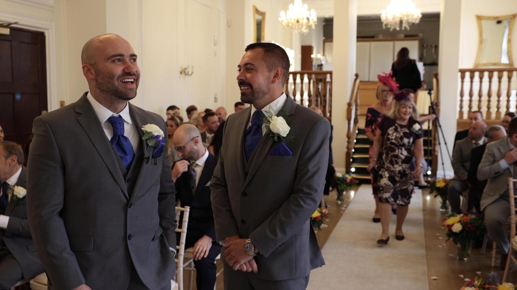the groom and best man laugh waiting for the ceremony to start