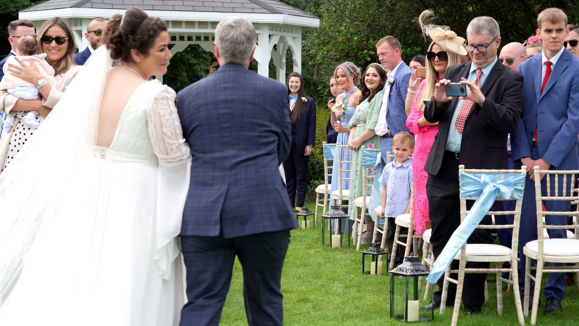 the bride takes a breath before walking down the aisle at The Aviary in Ormskirk
