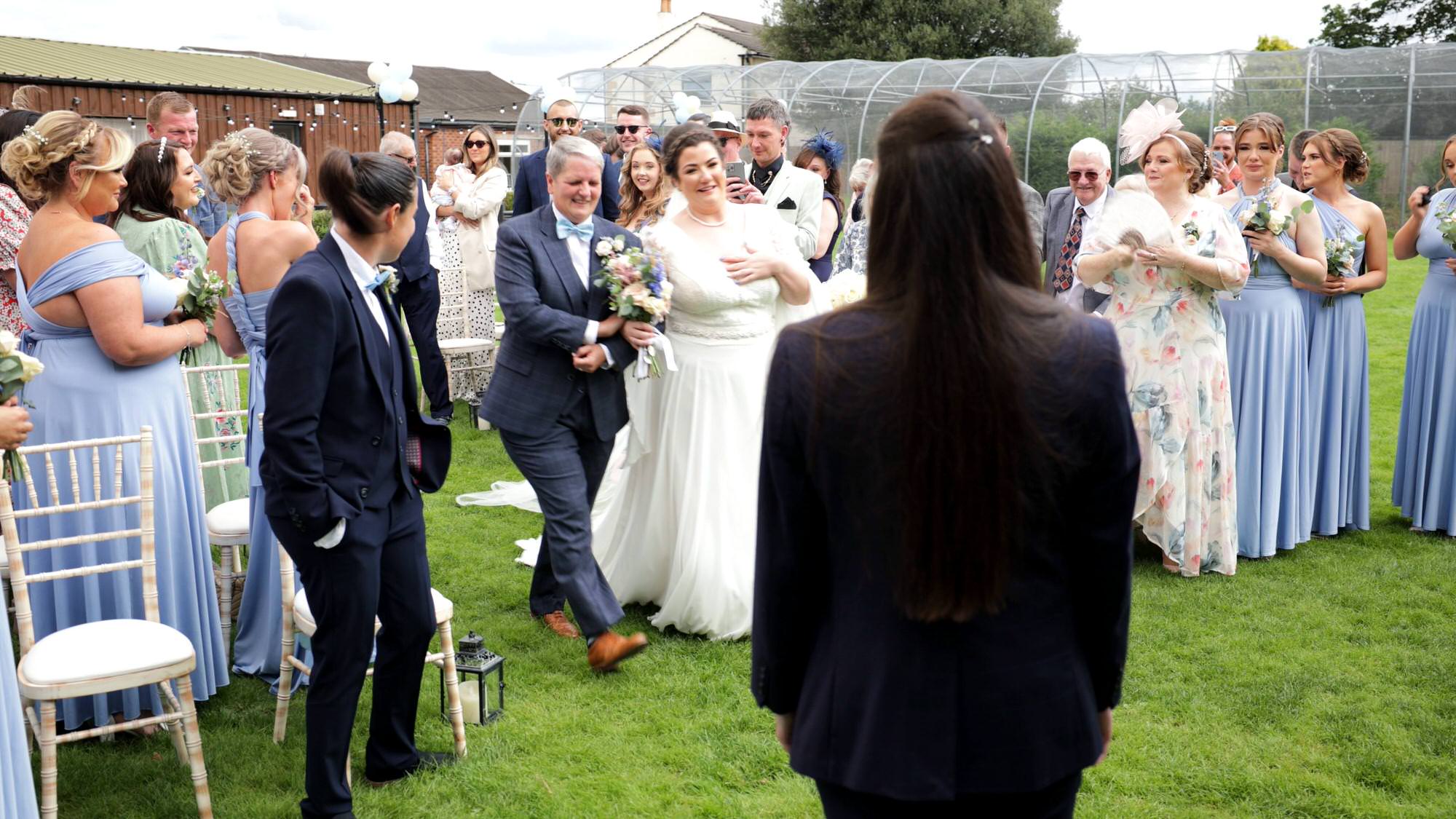 the brides laugh at each other crying during the outdoor wedding at The Aviary in Ormskirk