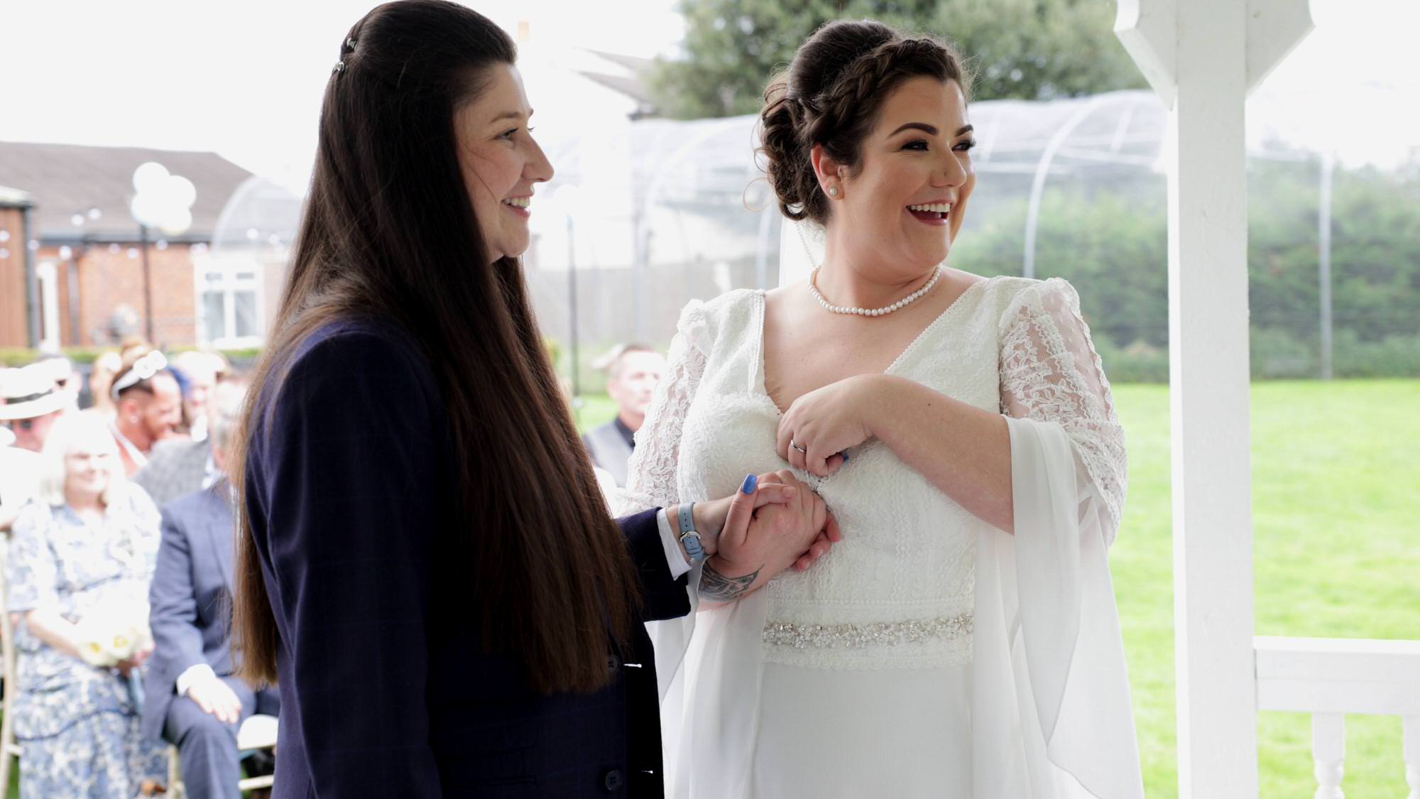 the couple laugh with the lancashire registrar at The Aviary in Ormskirk