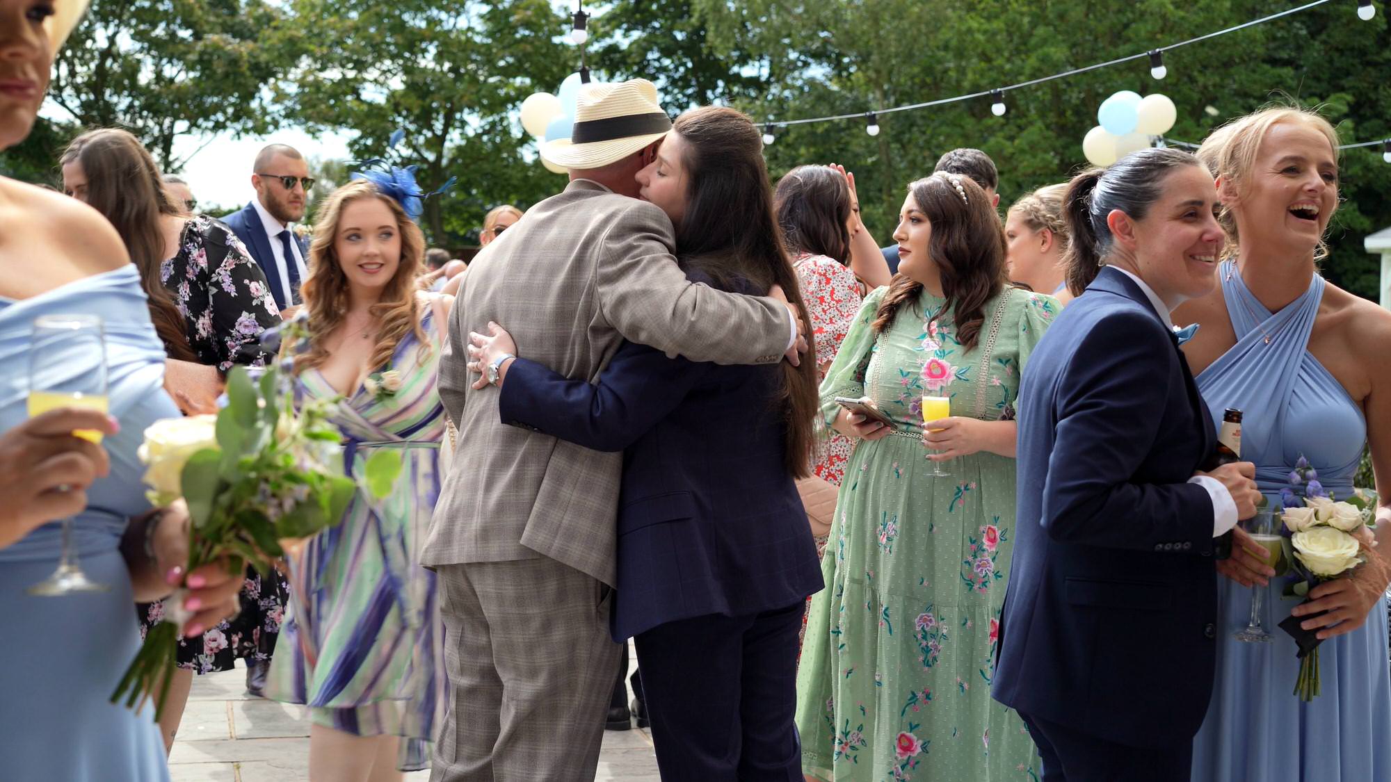 guests hug during the wedding reception at The Aviary in Ormskirk