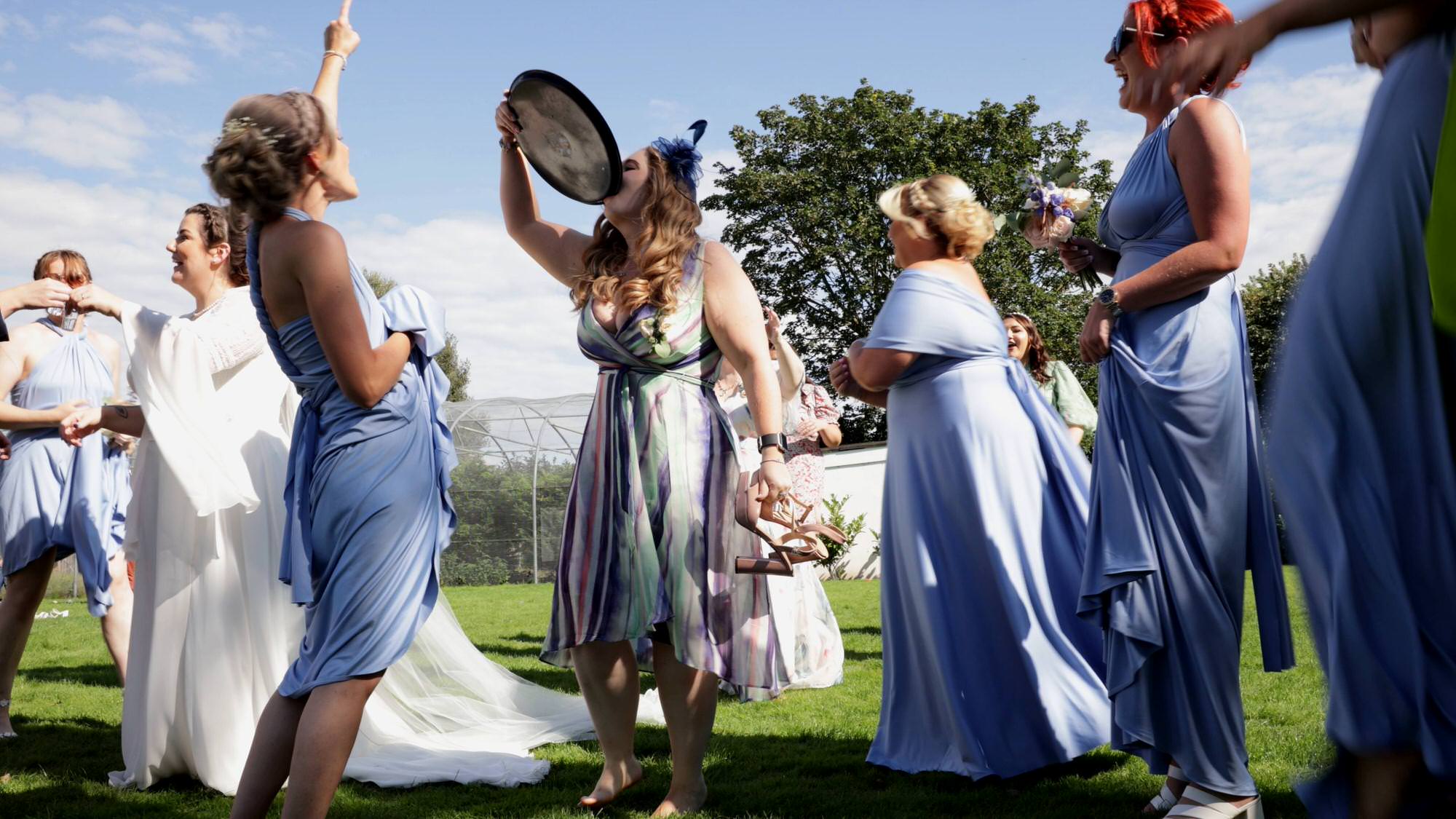 a guests drinks from a drinks tray during a game