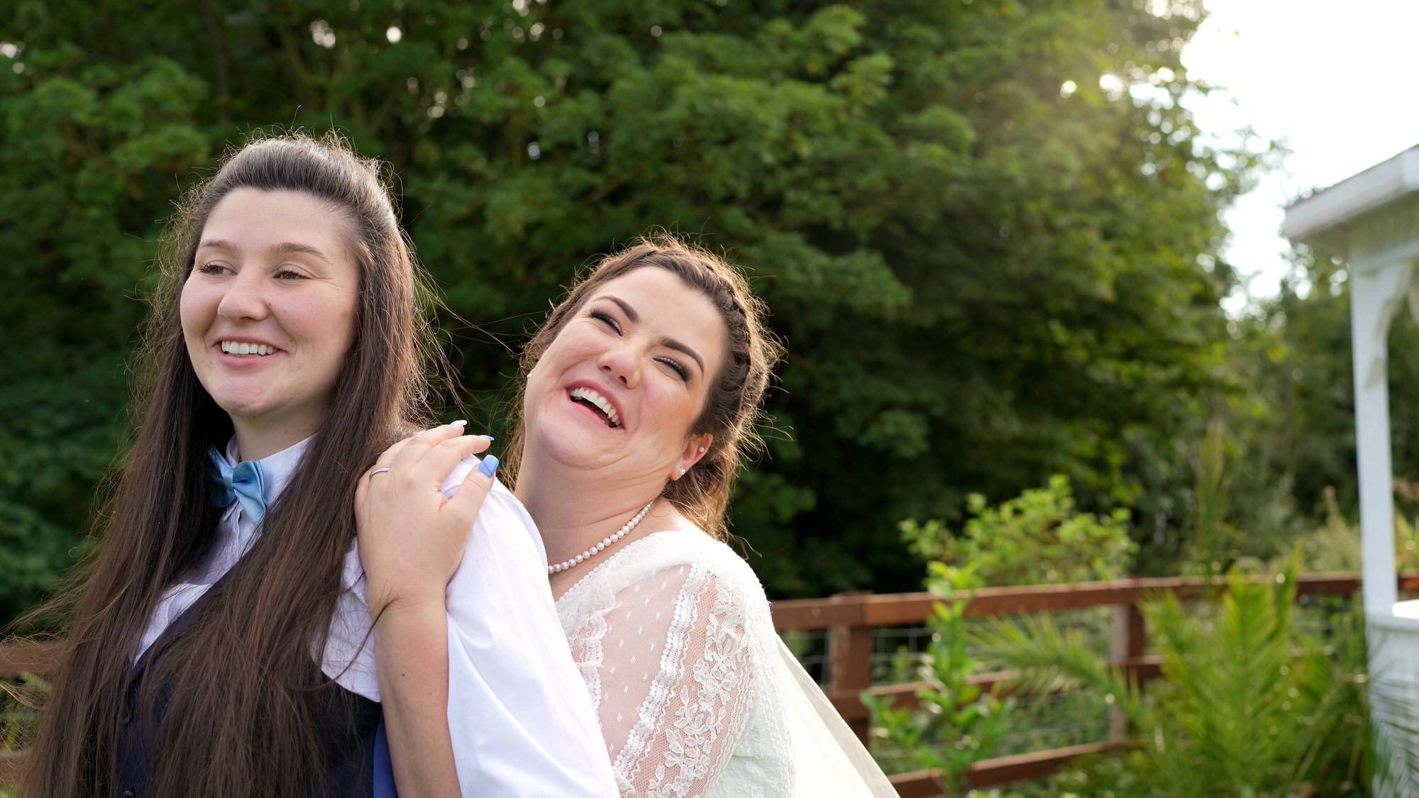 The couple try a natural pose for the photographer and laugh