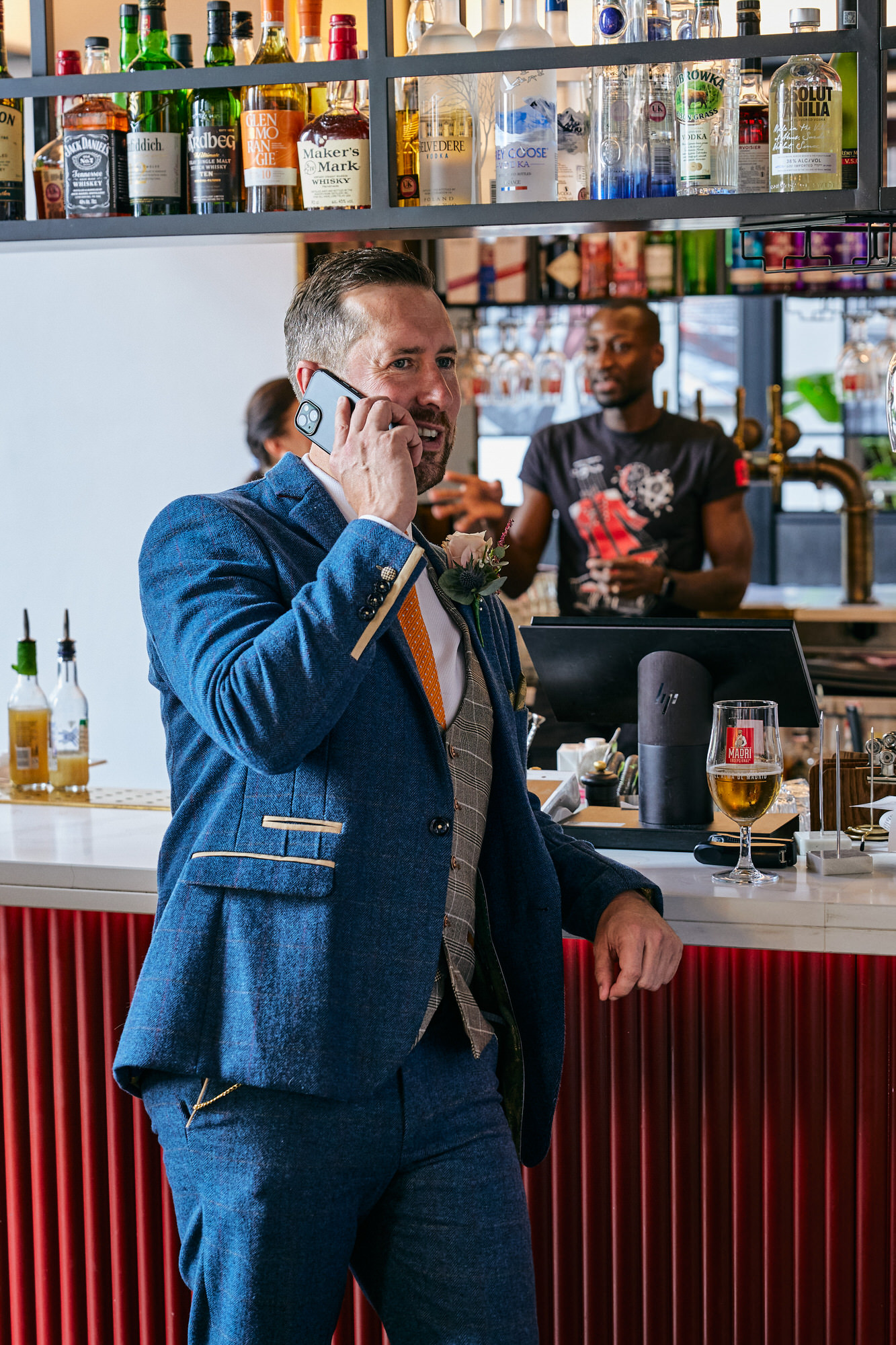 a photo of the groom being casual on his phone