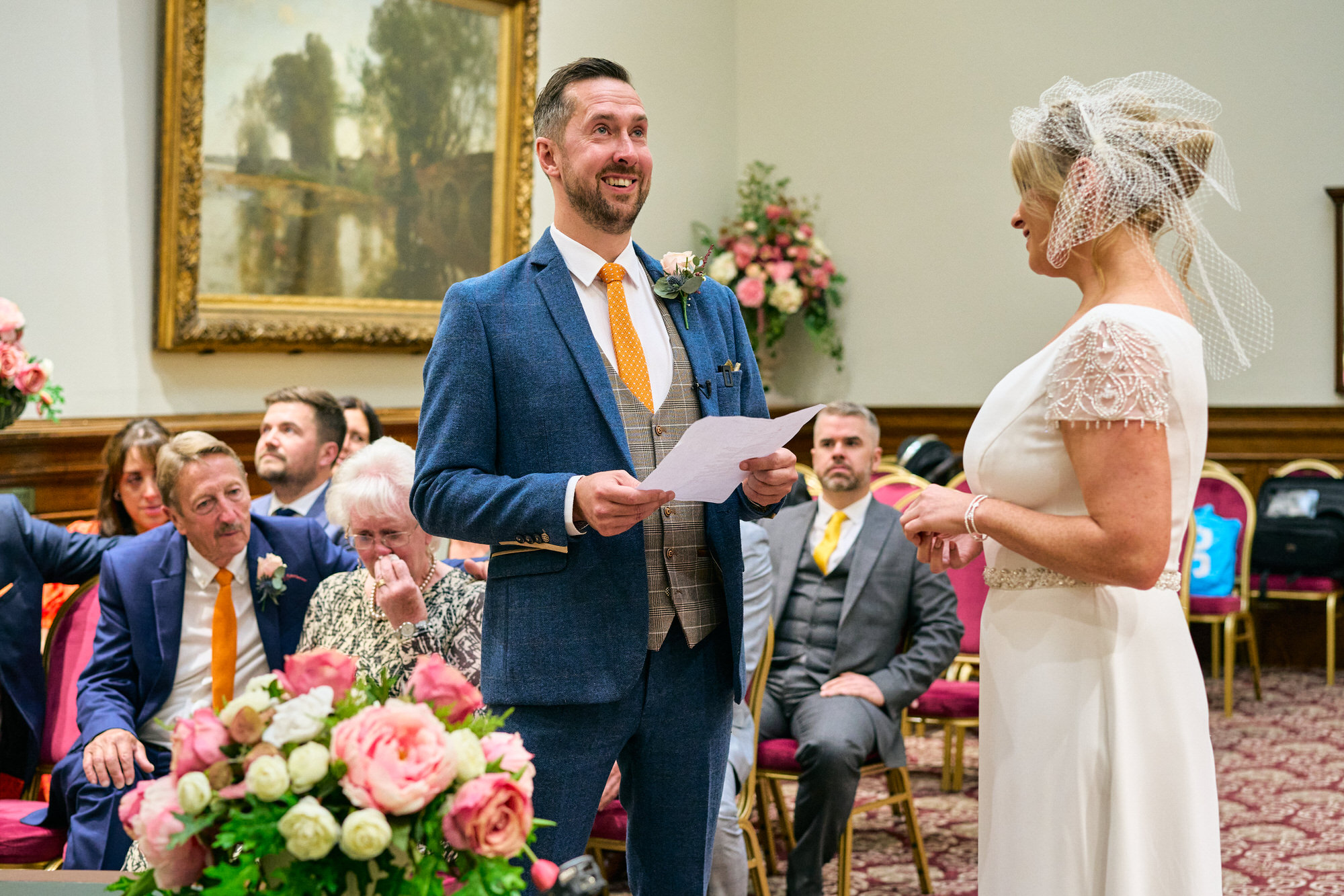 Groom takes a pause to stop the tears during a wedding ceremony in the Grand Jury Room