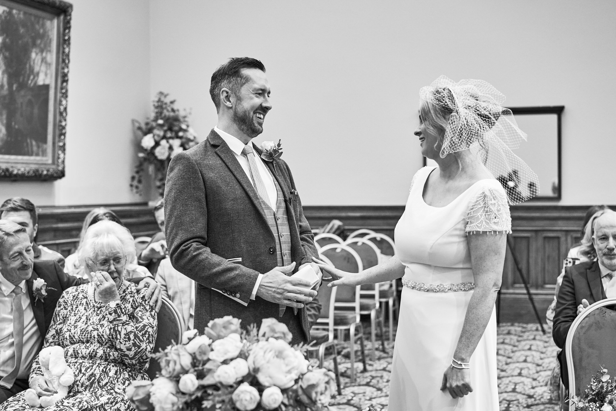 a photo from an intimate ceremony a natural photo of a Bride holding back tears as she walks down the aisle at St Georges Hall