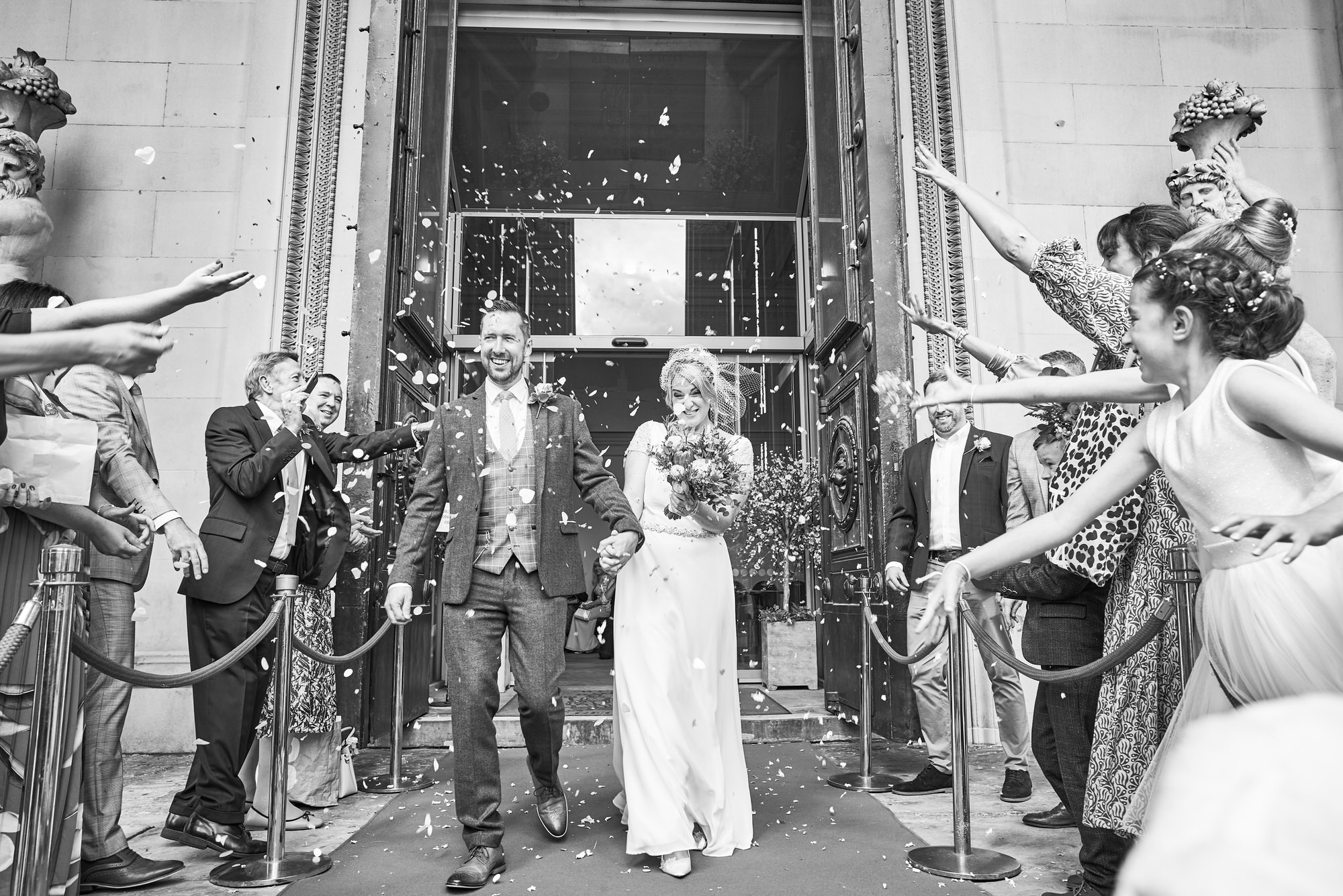 a photographer captures the confetti shot outside St Georges Hall in Liverpool