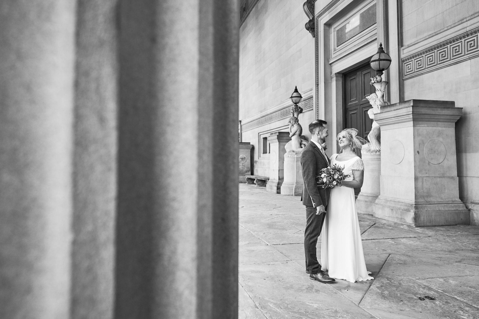 a couple chat for candid photos outside St Georges Hall