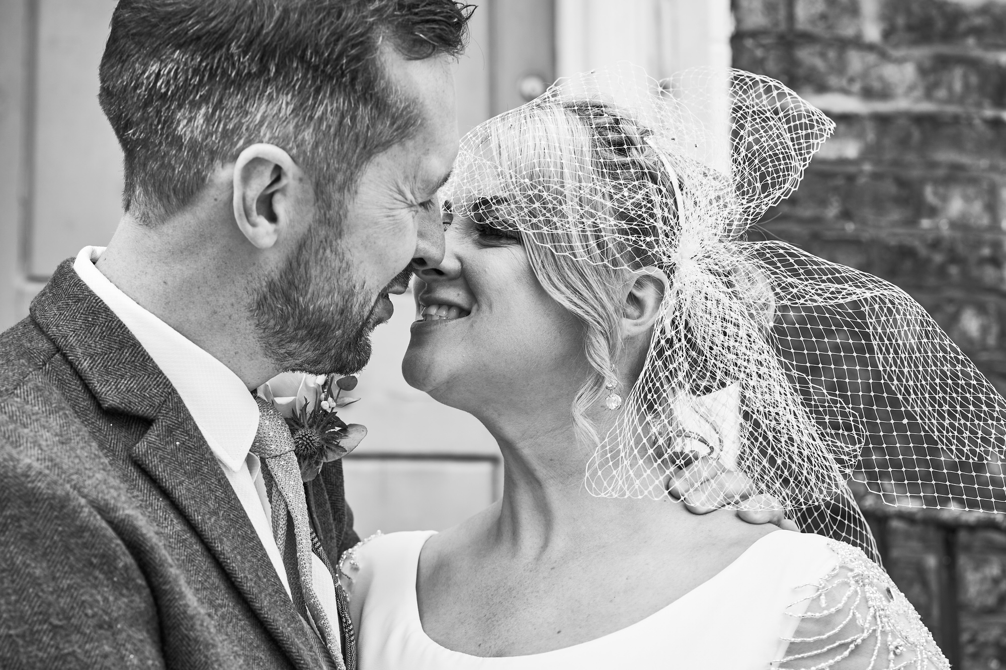 a natural moment of a couple having a kiss before their wedding meal