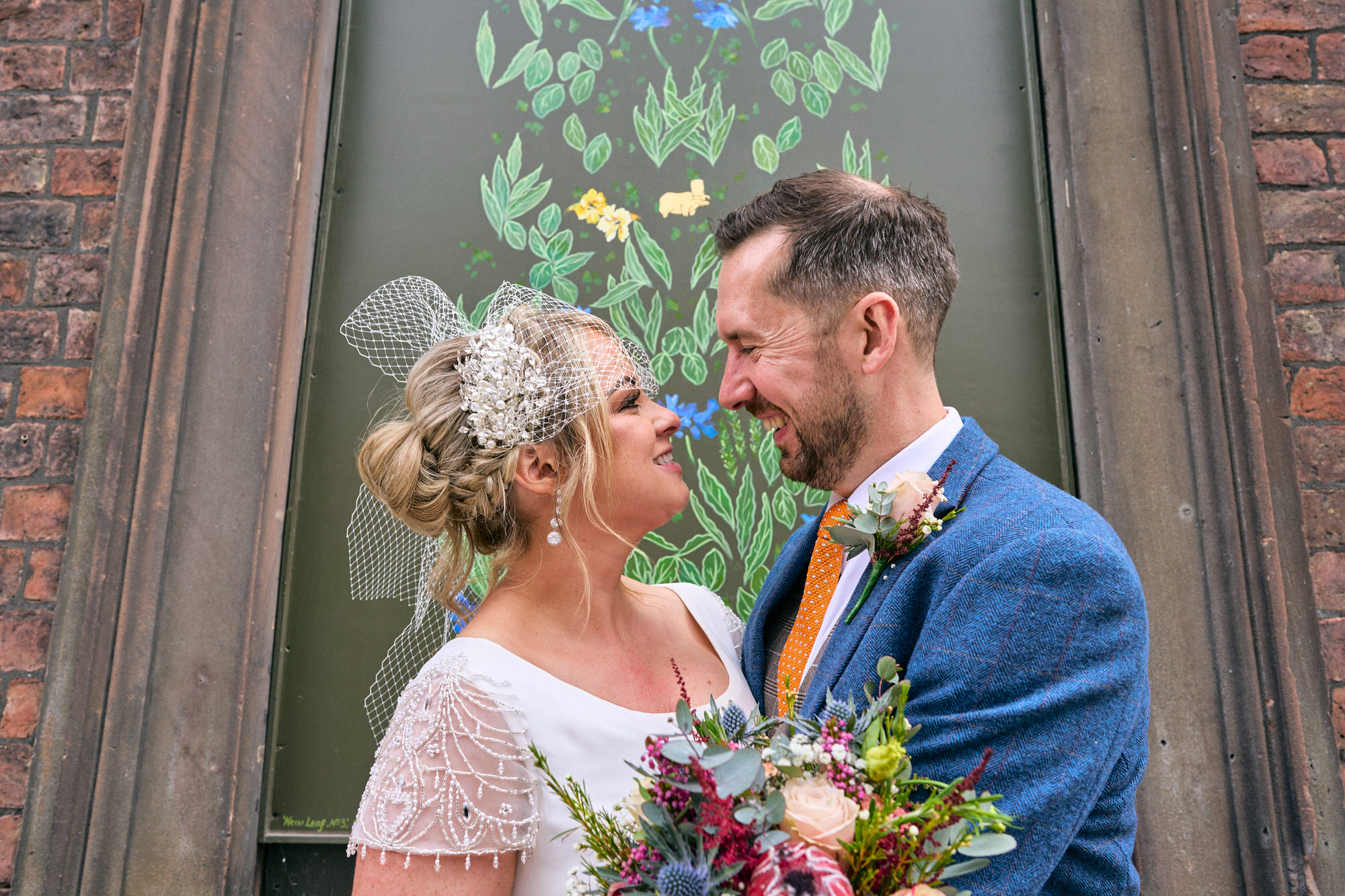 a couple pose for phots before having their wedding meal at The Art School Liverpool