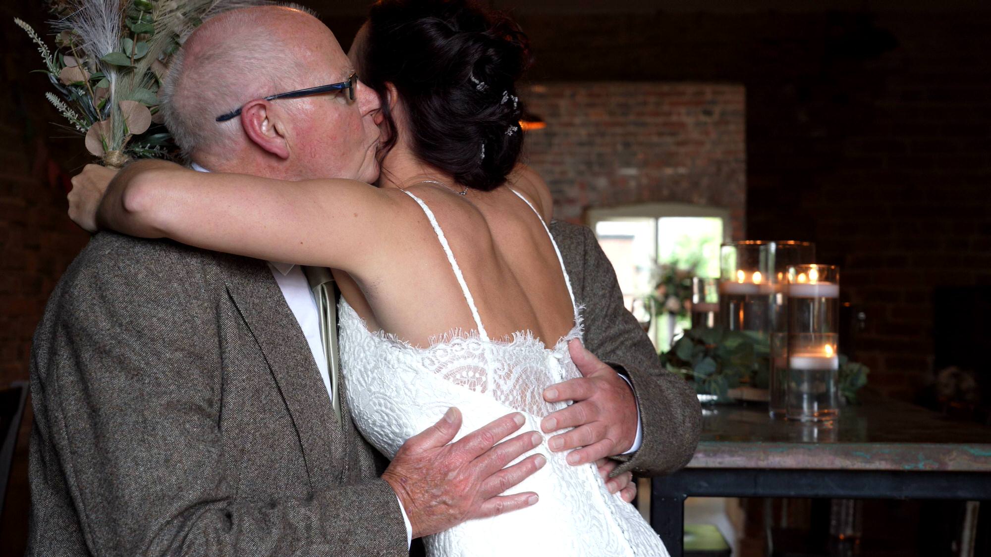 a bride hugs her grandad before walking down the aisle