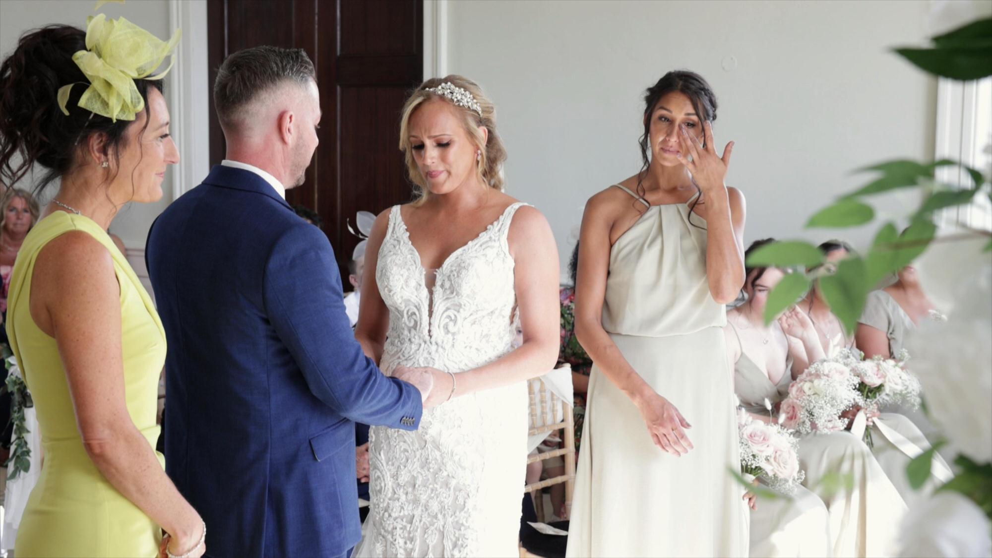 a couple exchange wedding rings during stubton hall wedding ceremony
