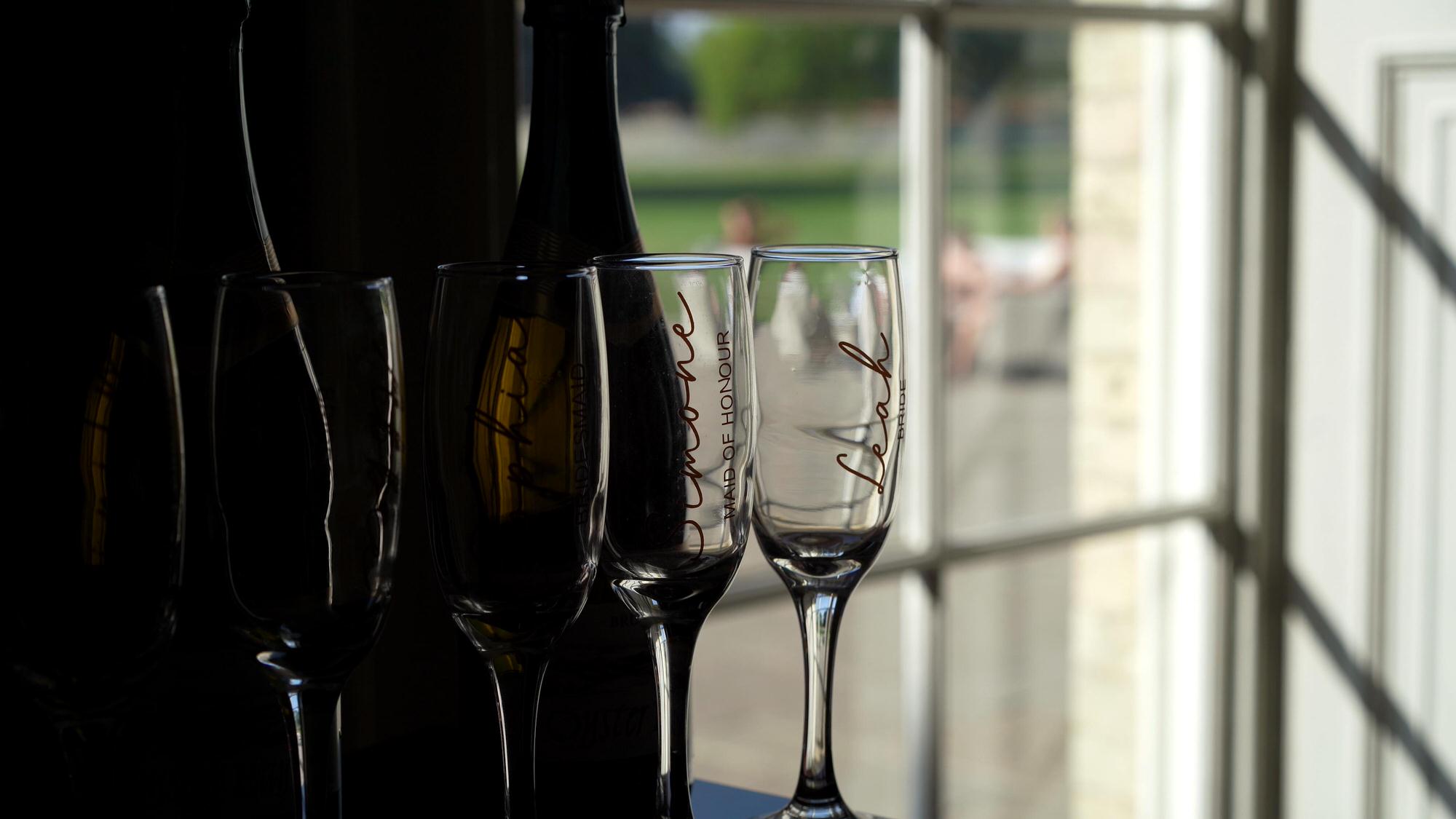 creative video still of a brides champagne glass by a window