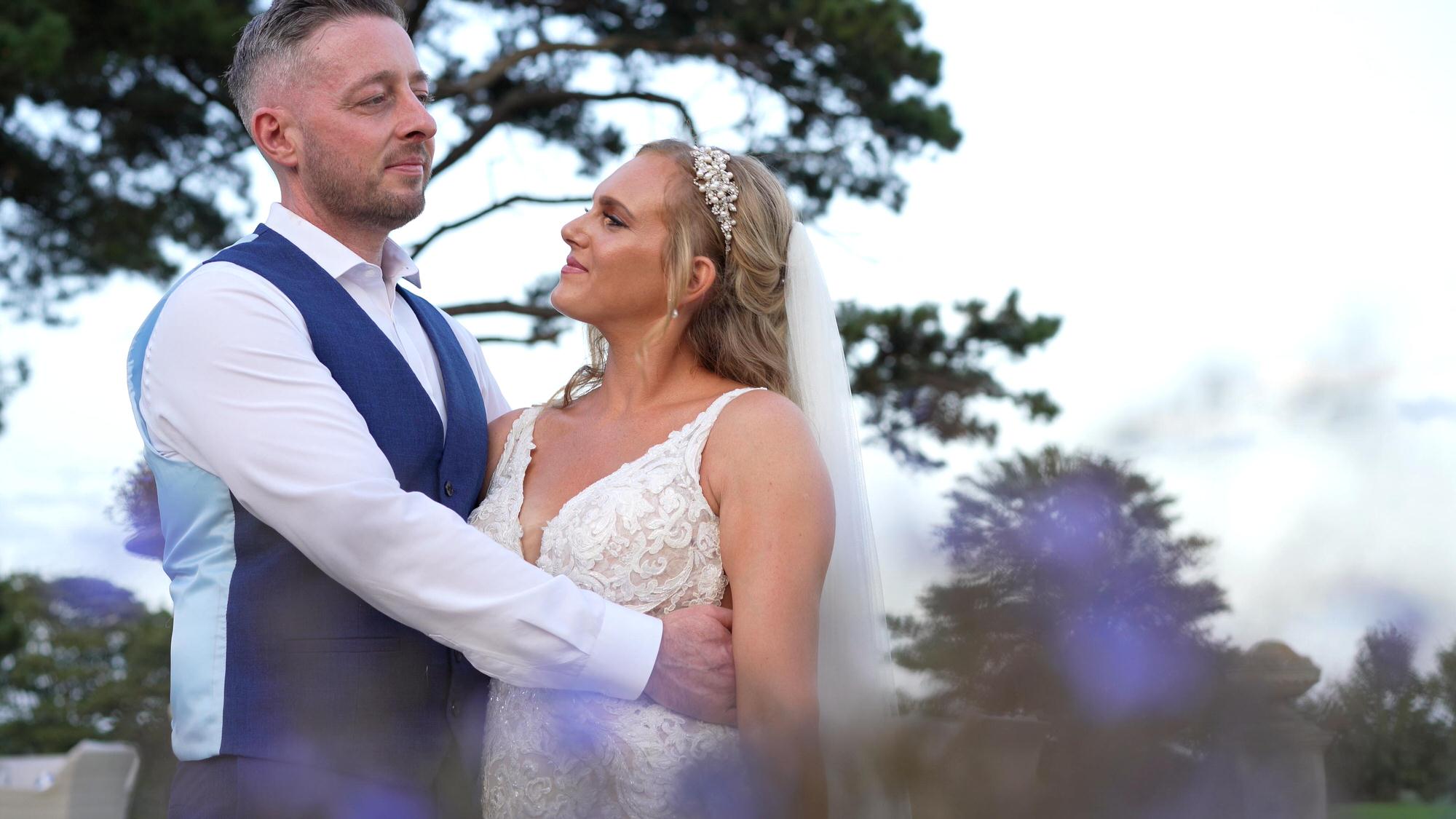 a natural moment of the bride looking up at the groom between posed photos