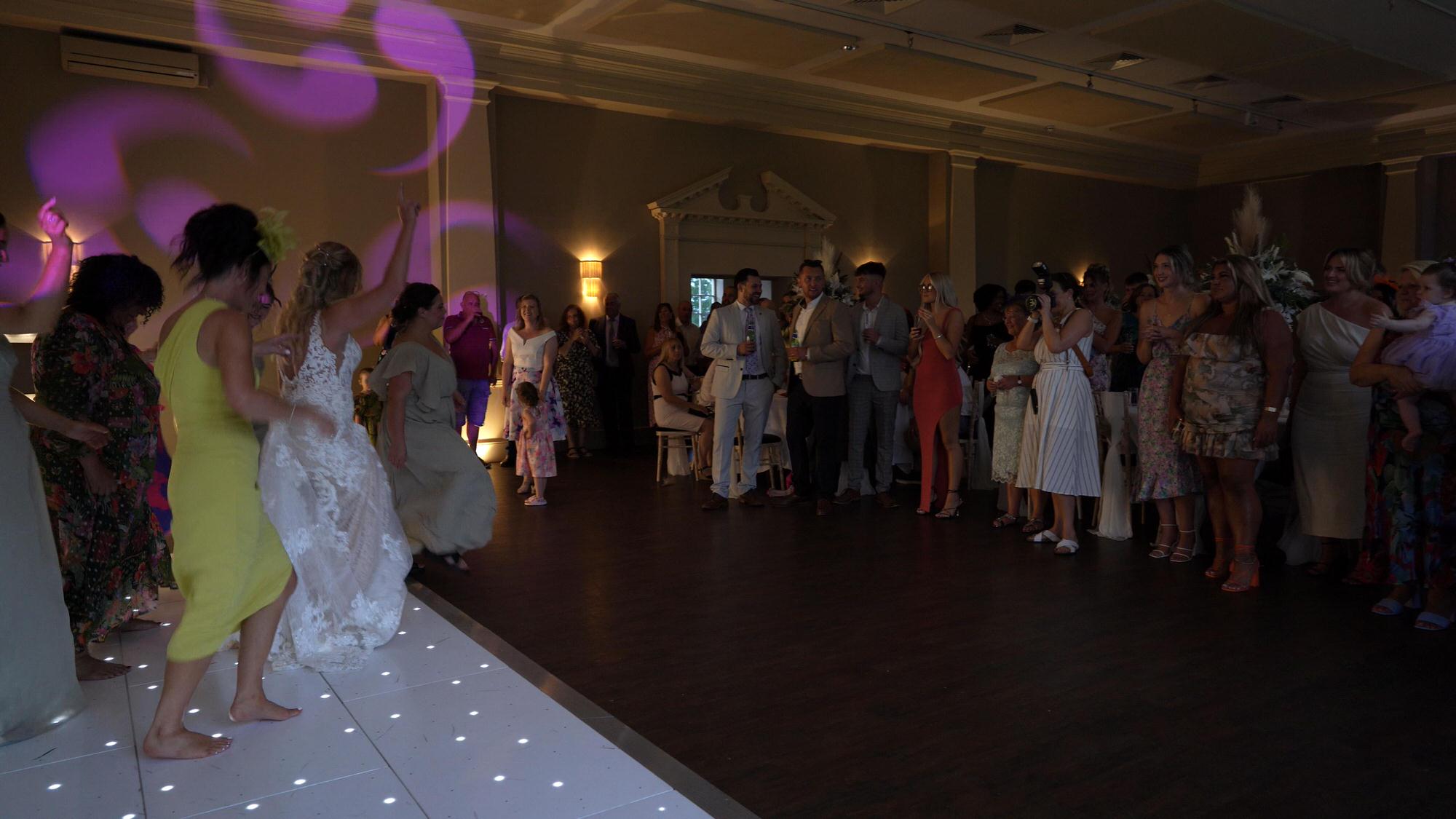 the bride and bridesmaids dance to Jerusalema as a flash mob