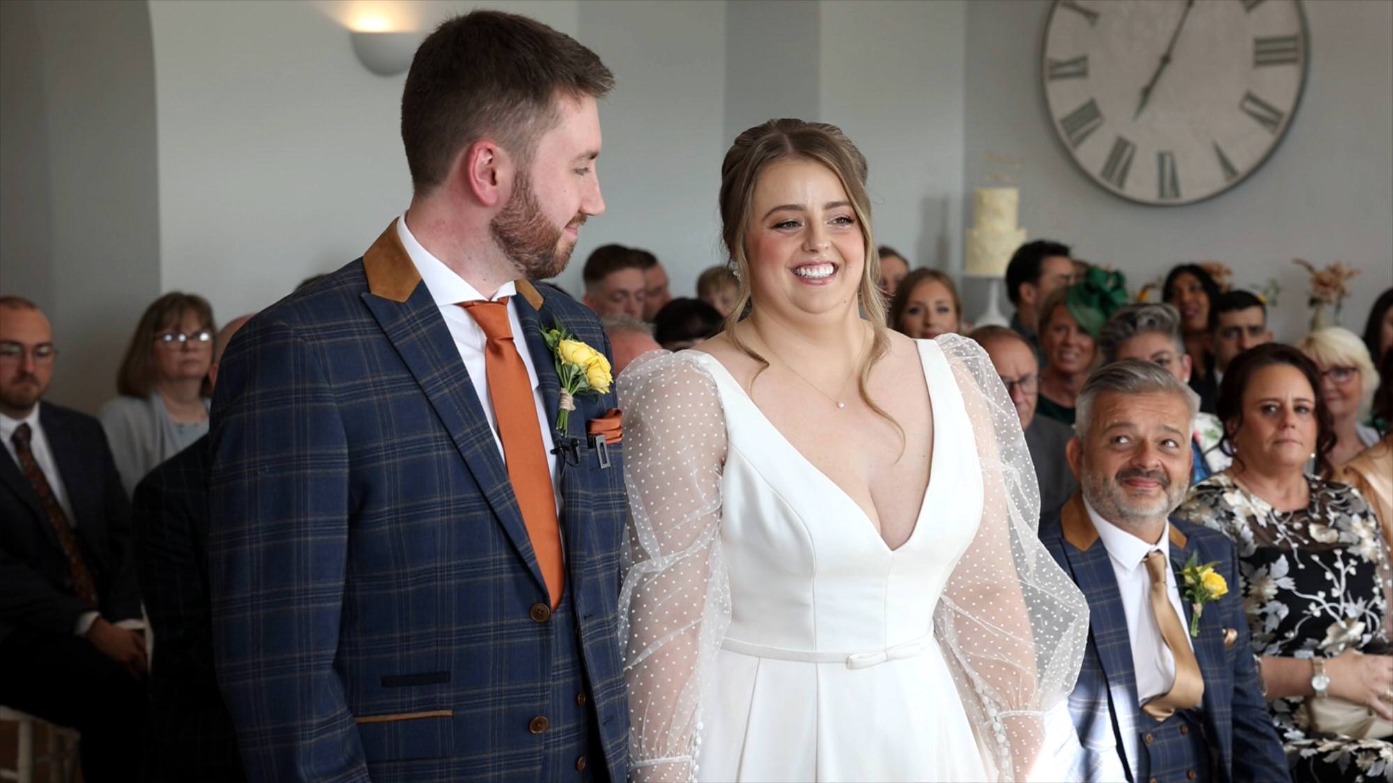 a natural shot of the groom looking at the bride during the wedding ceremony in the Lakes