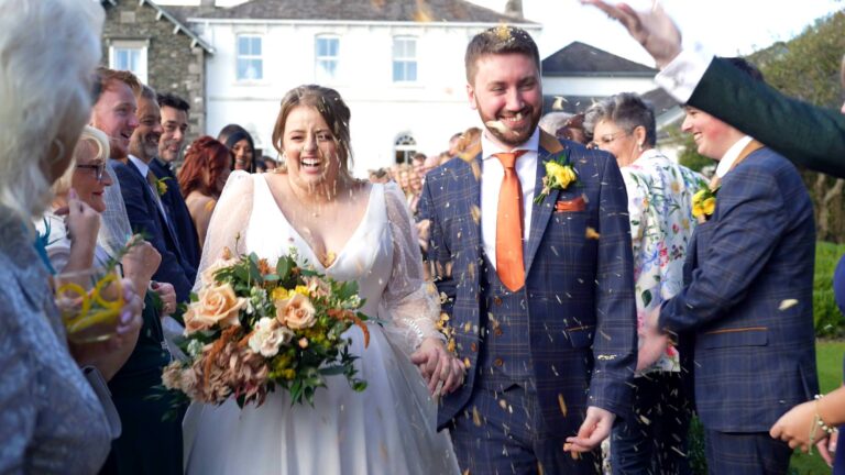a fun confetti shot by the videographer outside Cartmel Old Grammar