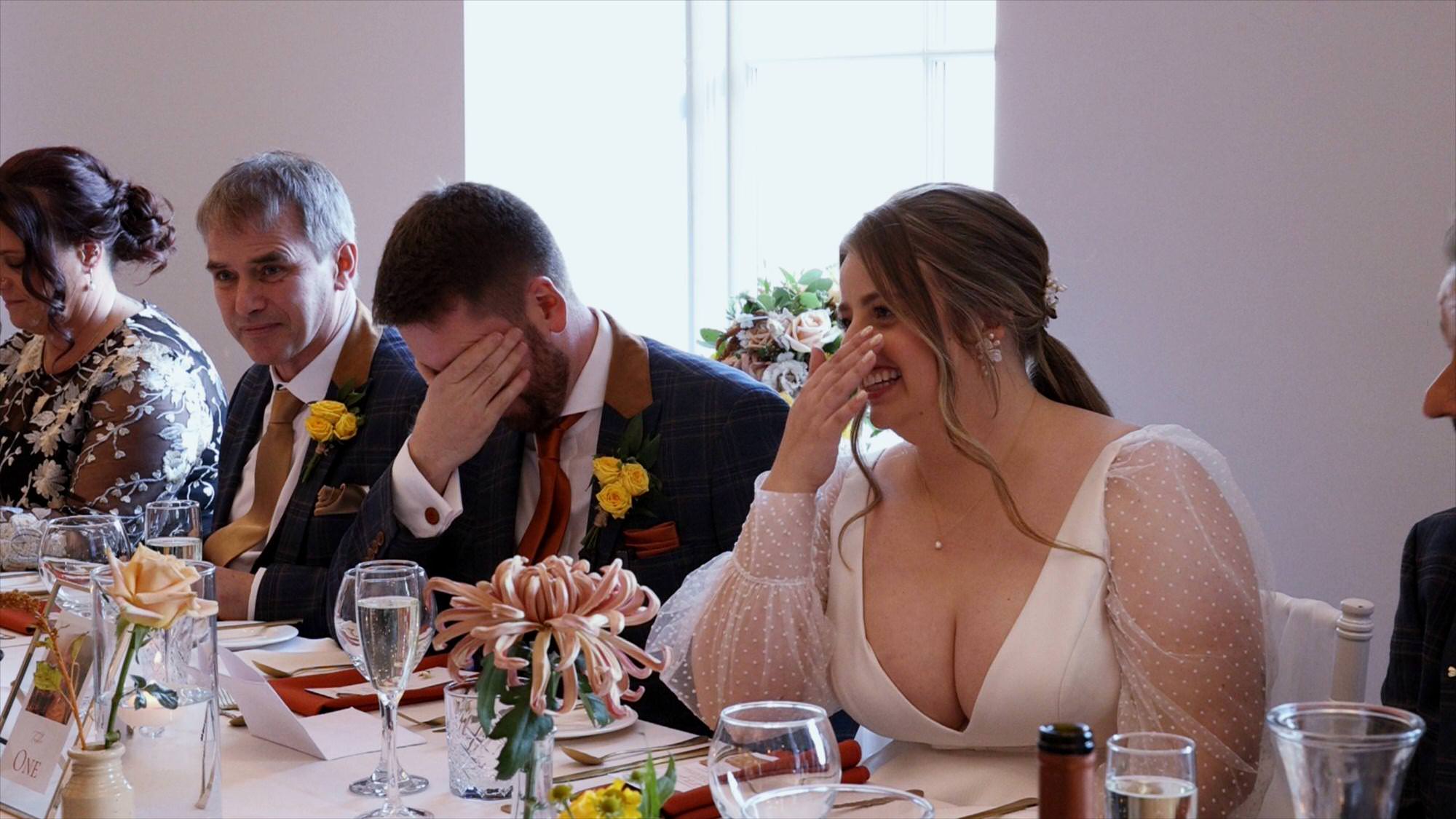 the couple look embarrassed during a speech at Cartmel Old Grammar in the Lakes