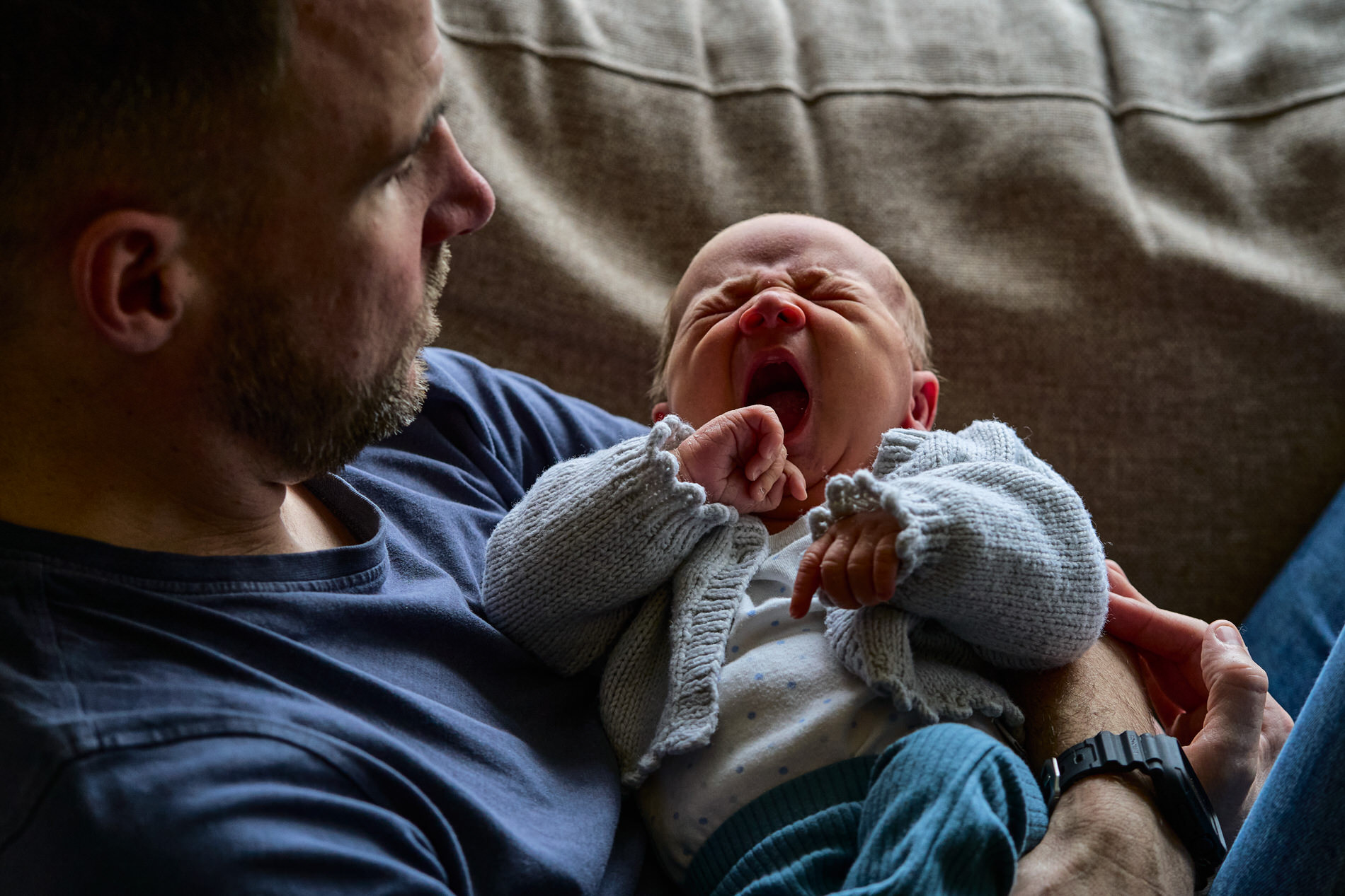family photographer captures a newborn baby yawning at home shoot