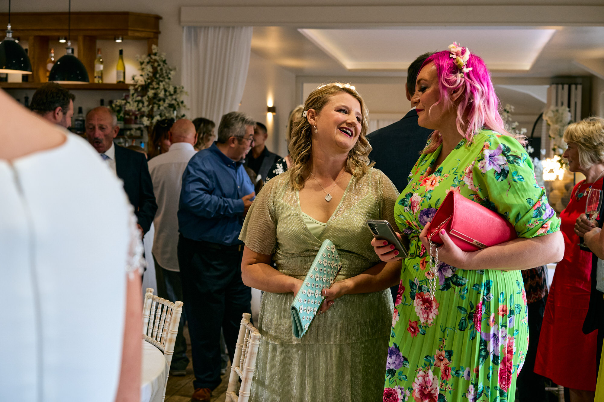 two female guests laugh along together