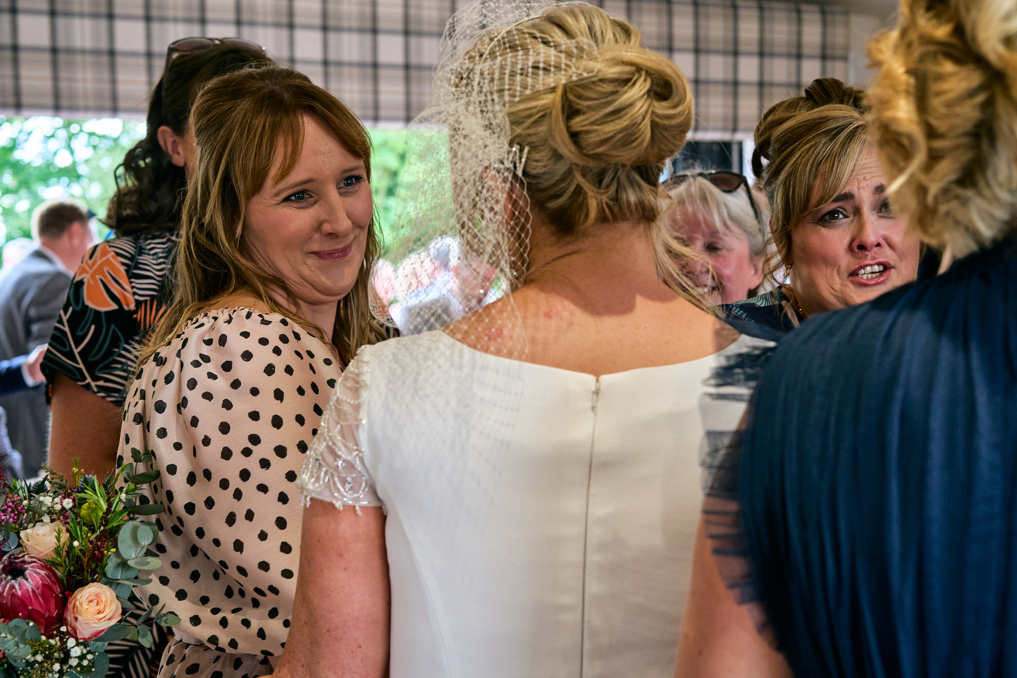 a guest smiles at the bride