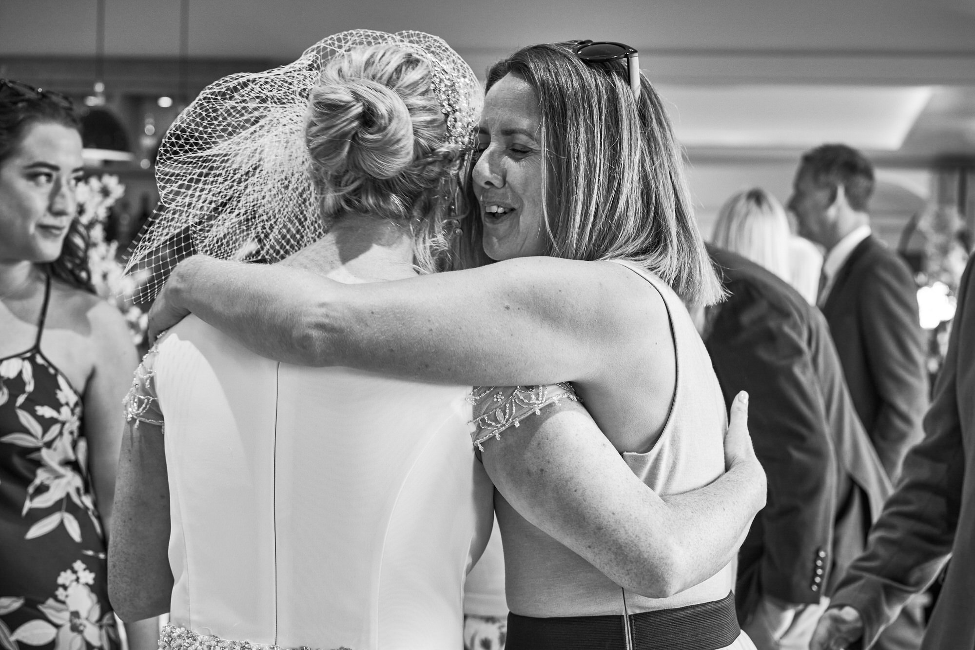 a guest hugs the bride