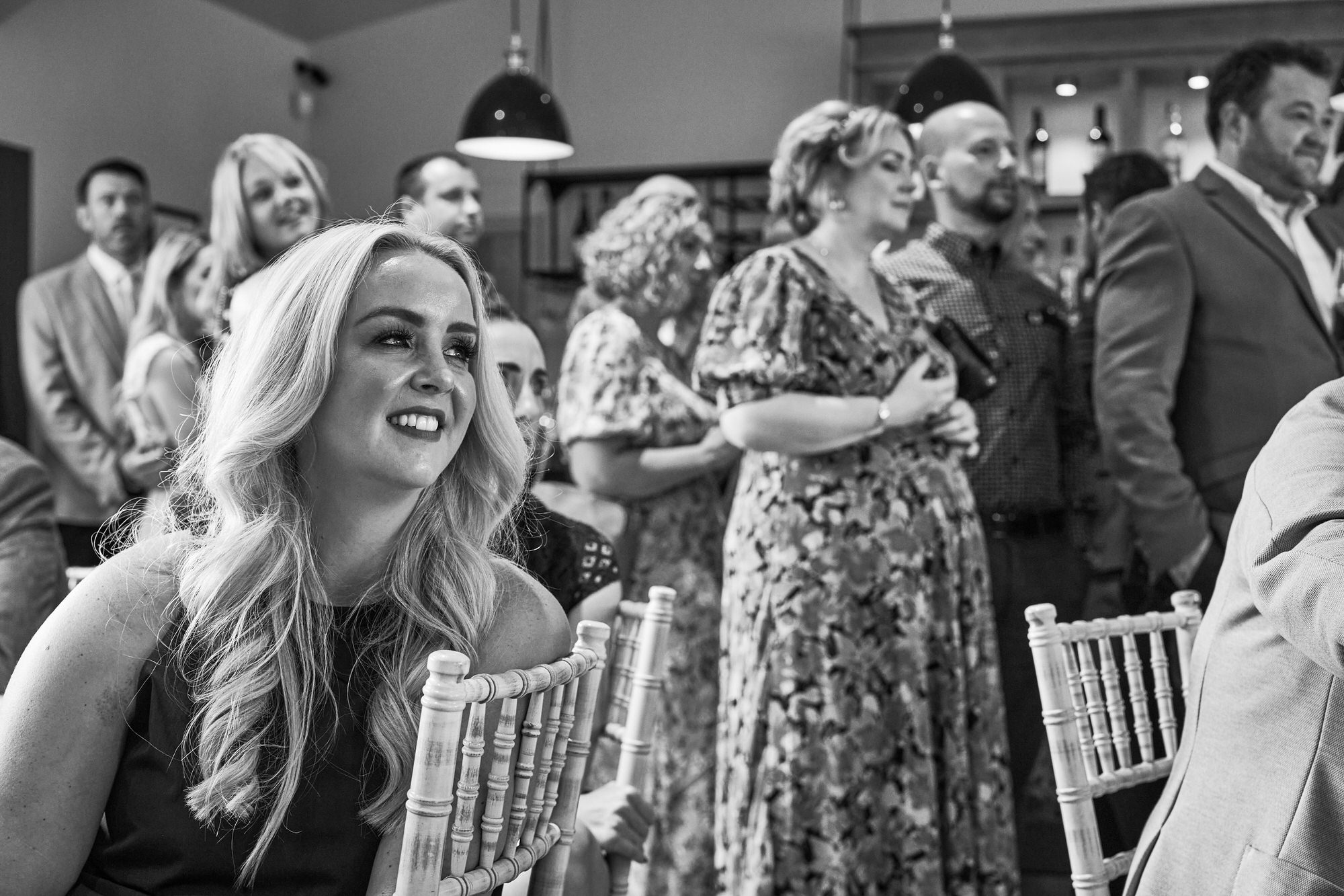 guests smile along with the wedding vows at The Aviary Ormskirk