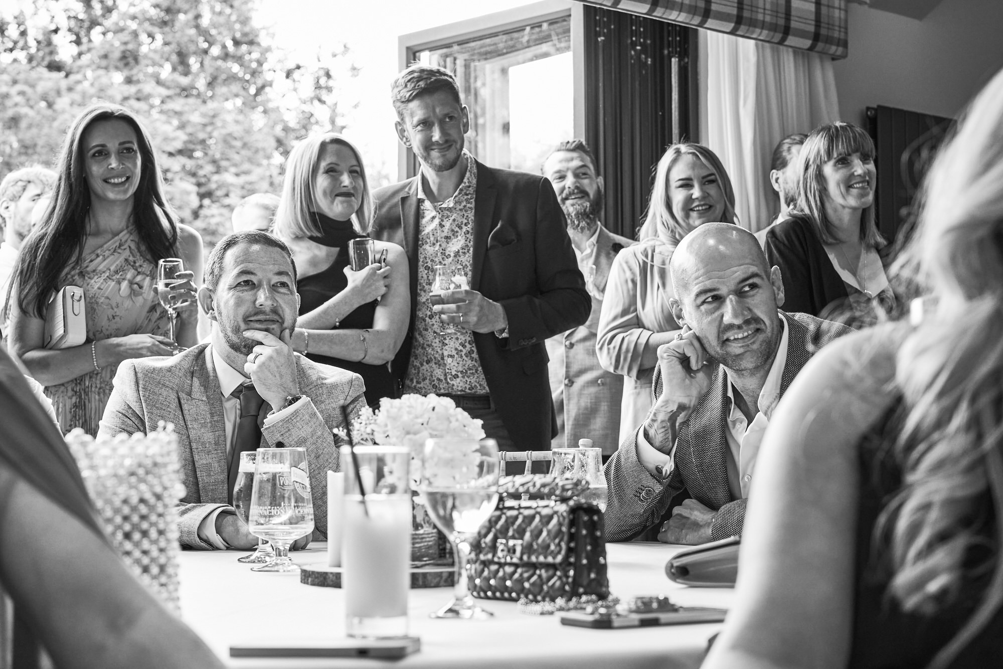 guests smile along with the wedding vow renewal