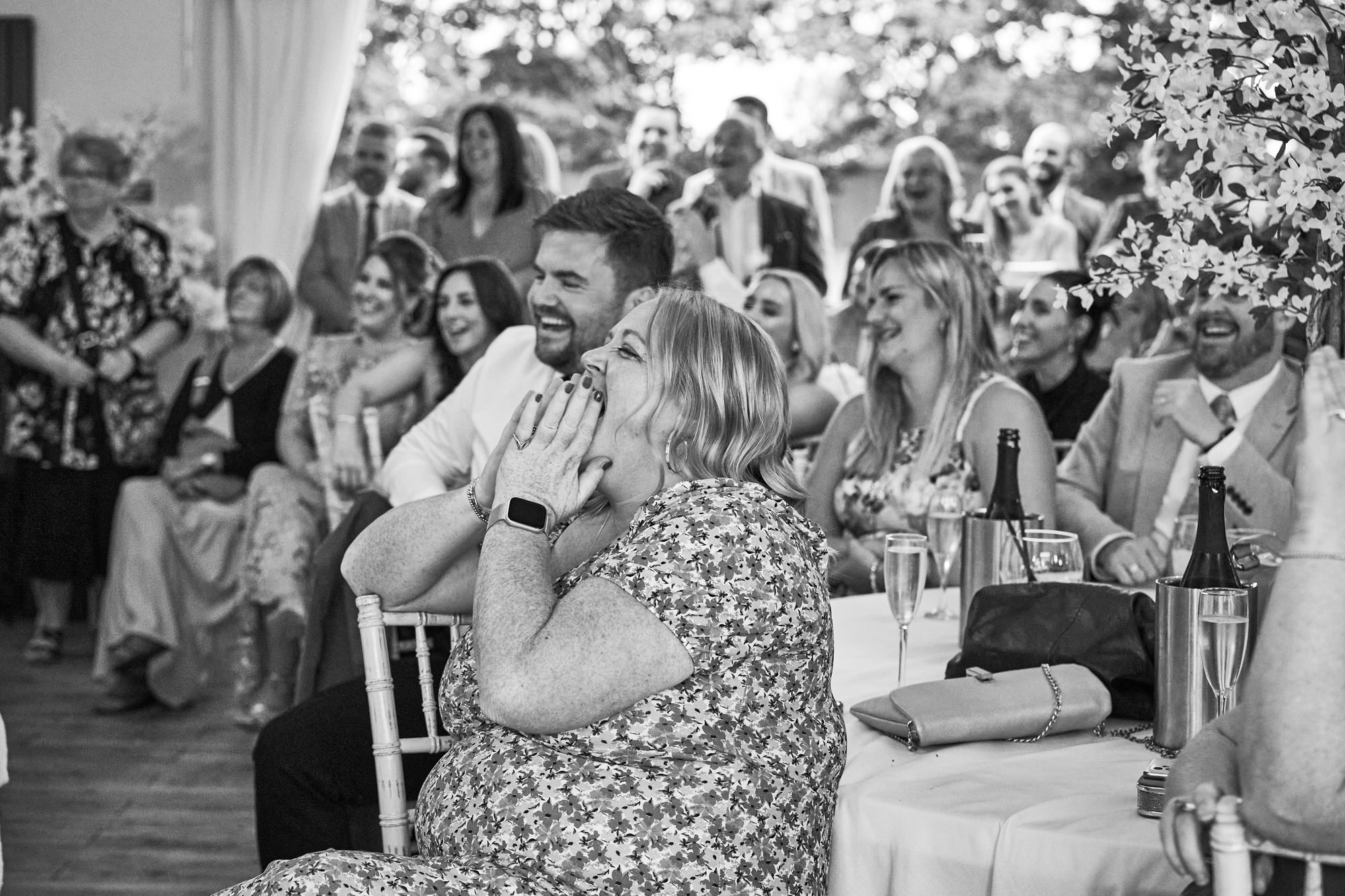 guests laugh and look shocked during speeches