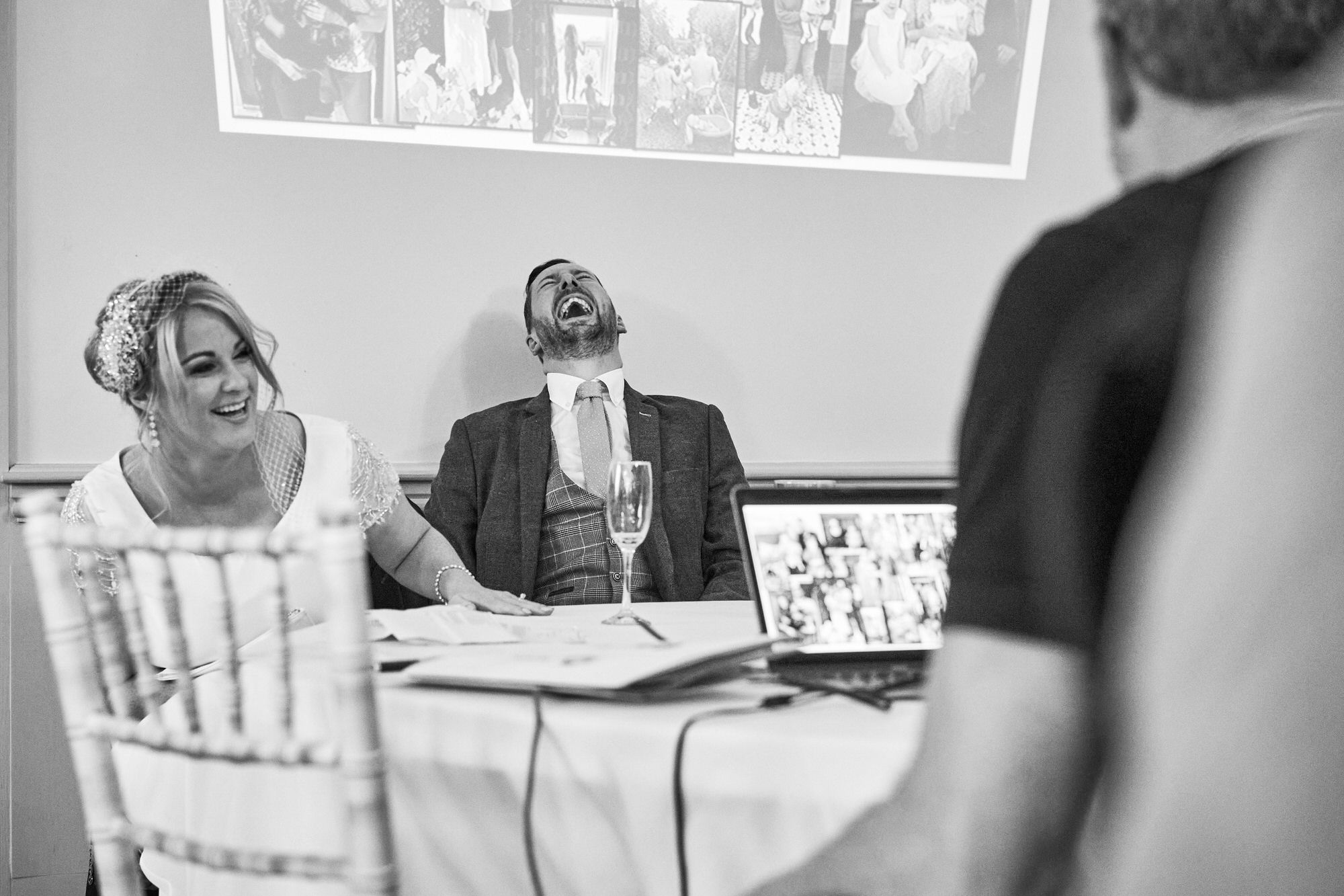 the bride and groom belly laughing during her dads speech at The Aviary Ormskirk