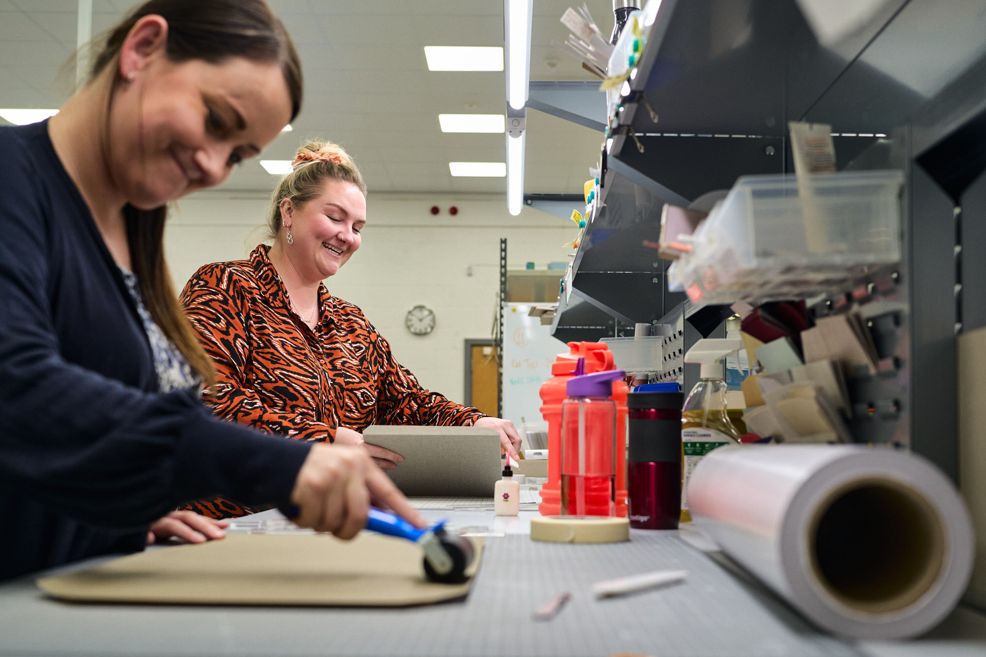 two people at Folio albums create products in the workshop