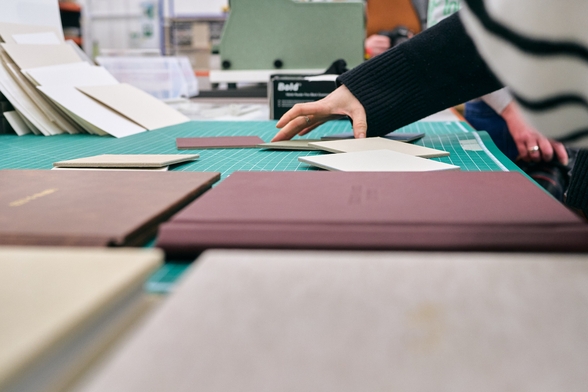 someone chooses a sample of cover material to demo a type of font